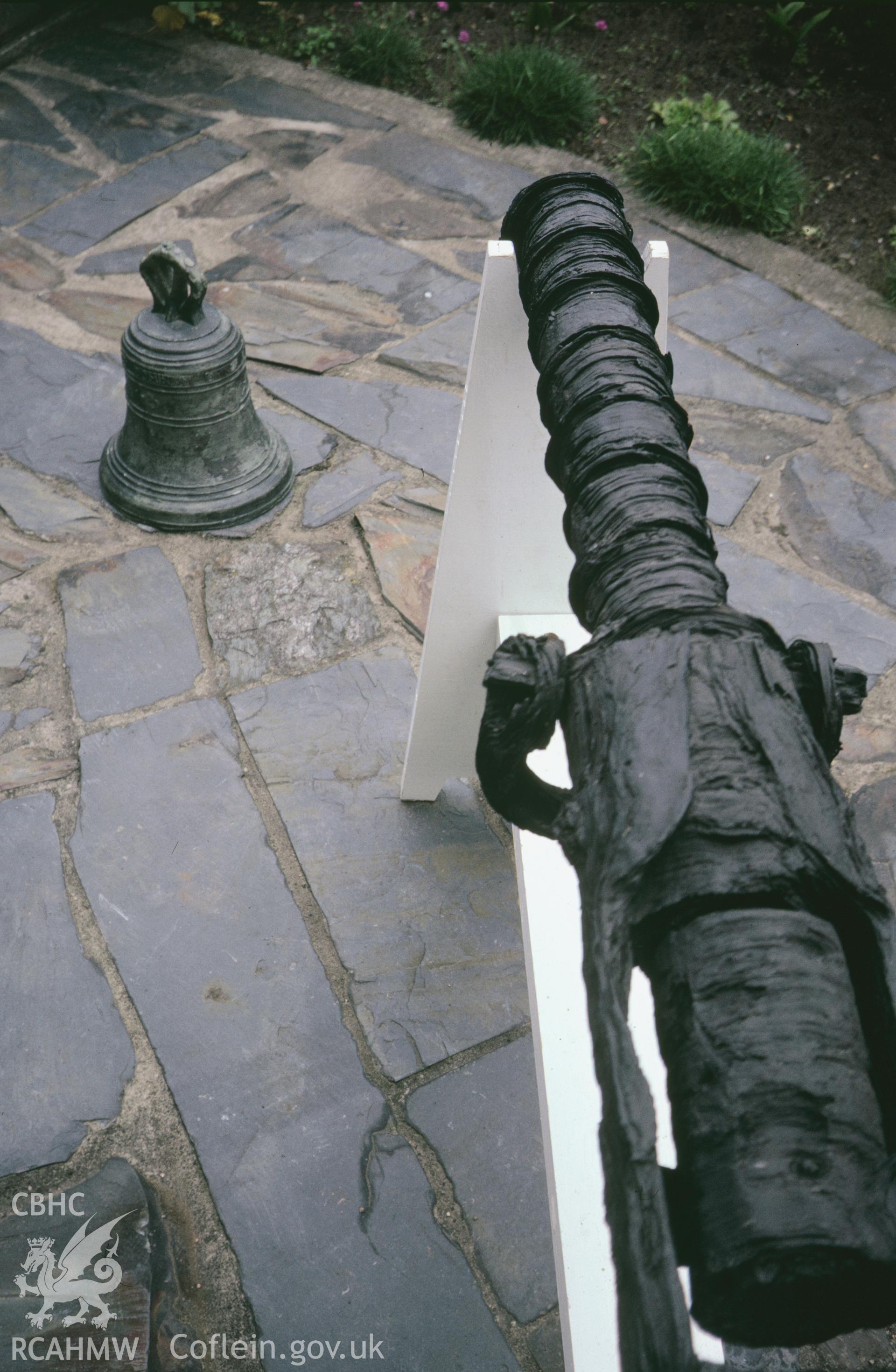View showing breech loading gun recovered from the wreck and the ships bronze bell, one of a set of 41 colour slides from an underwater survey of the Tal-y-Bont designated shipwreck, carried out by the Archaeological Diving Unit.