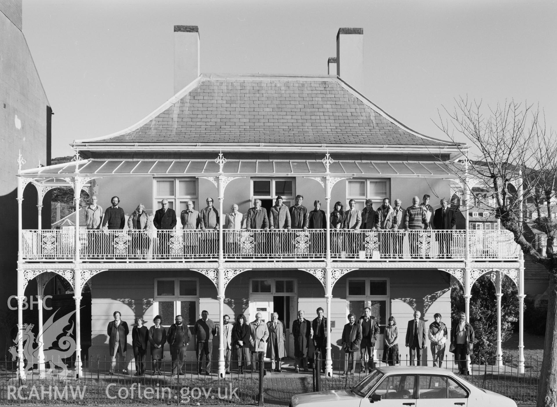 Two copies of a black and white photograph showing RCAHMW staff and commissioners taken outside Edleston House,  Autumn 1989.