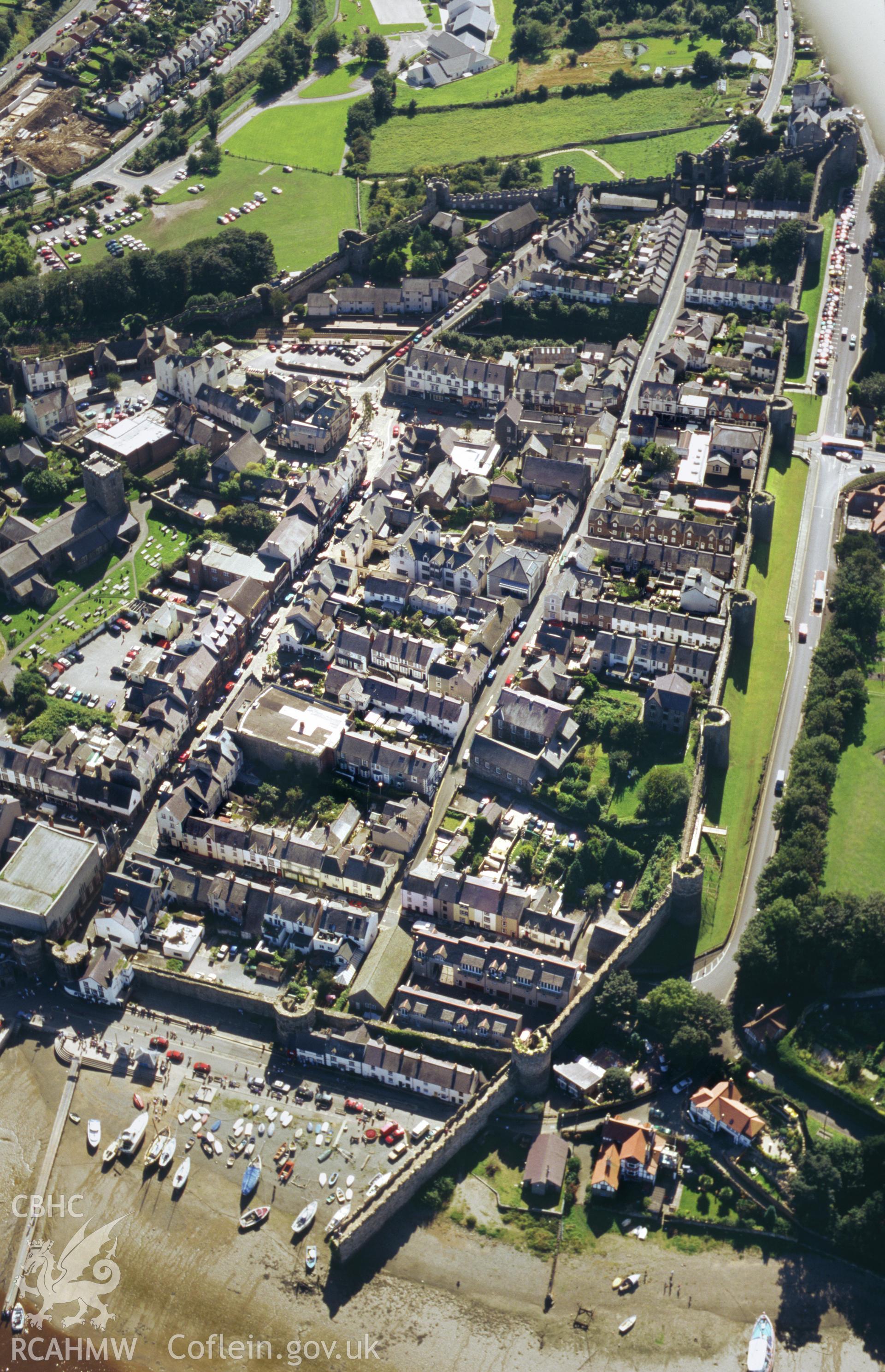 RCAHMW colour oblique aerial photograph showing the town walls at Conwy. Taken by Toby Driver 2004.