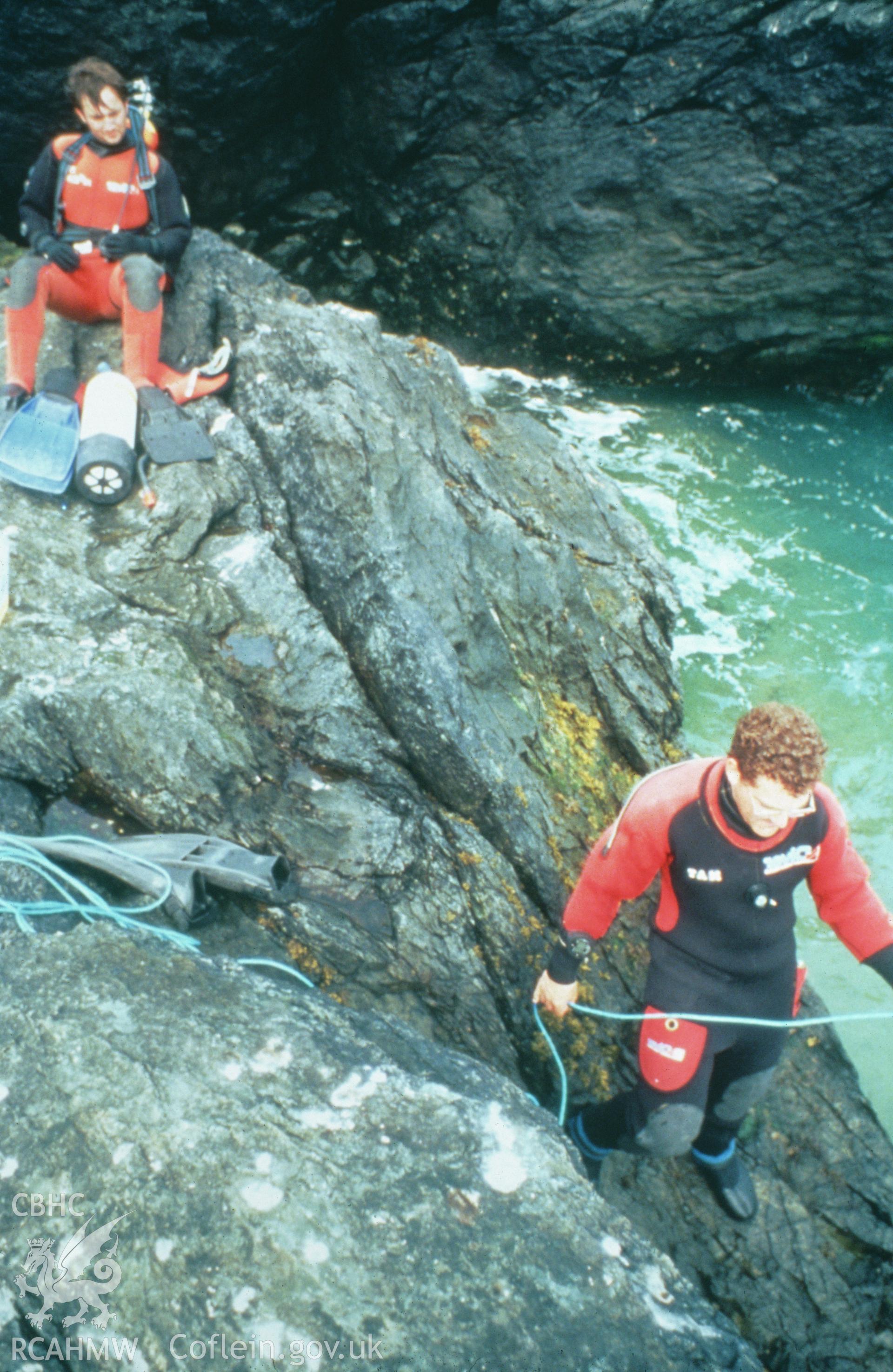 Colour slide of members of survey team on rocks, from a survey of the Mary designated shipwreck, courtesy of National Museums, Liverpool (Merseyside Maritime Museum)