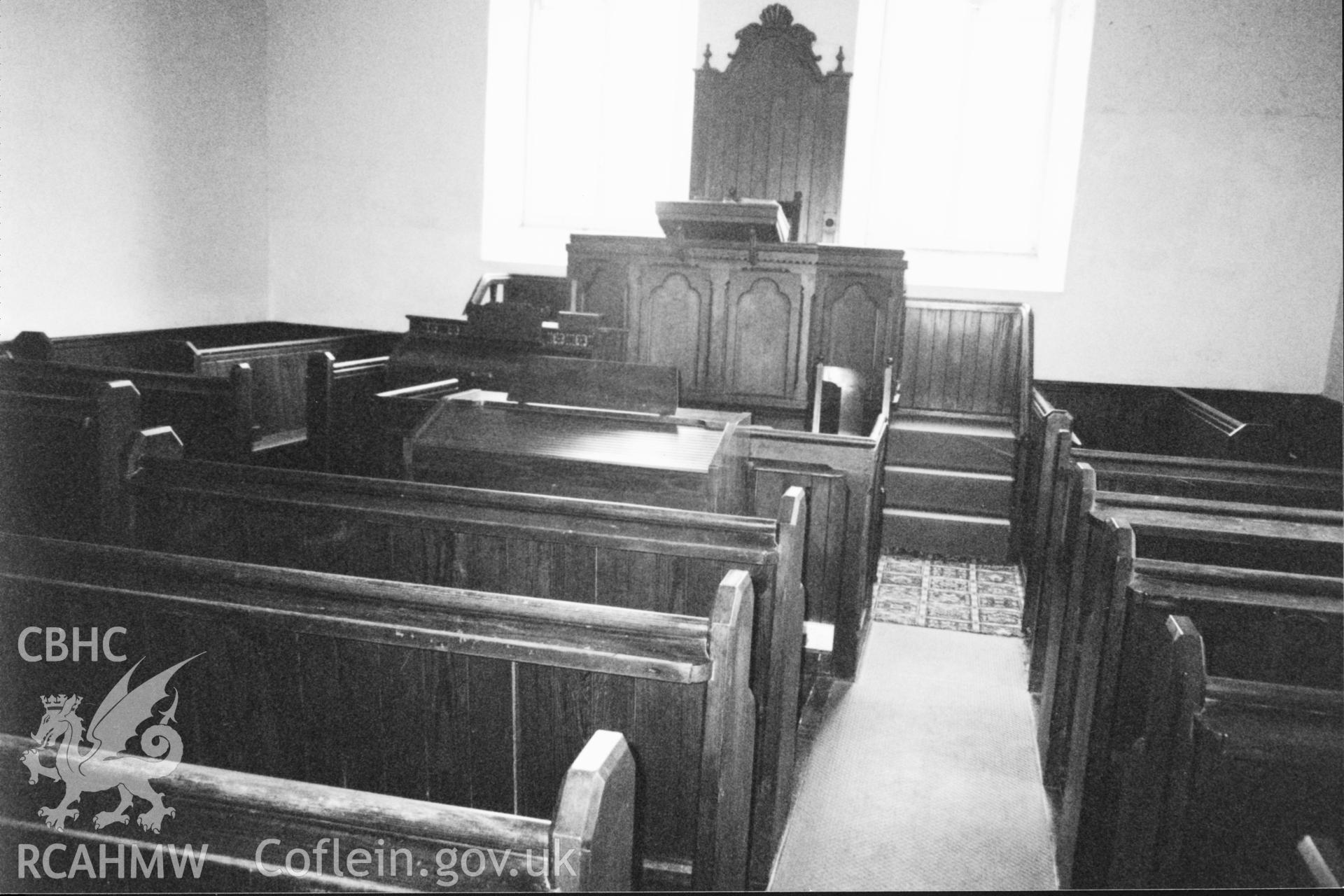 Digital copy of a black and white photograph showing an interior view of Bwlchgwynt Baptist Chapel, taken by Robert Scourfield, 1996.