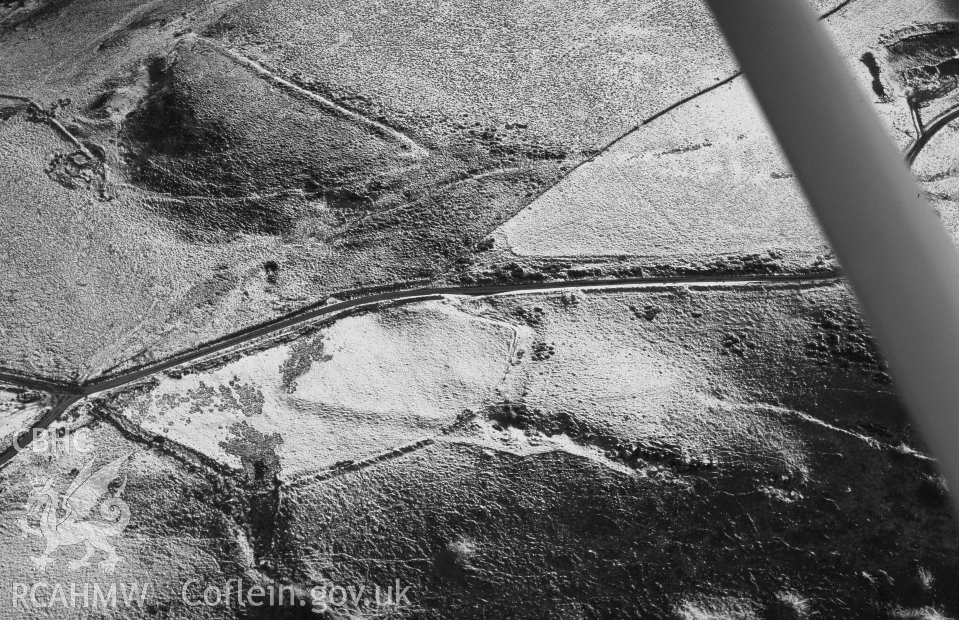 RCAHMW black and white slide aerial photograph of Bwlch Blaen Corn enclosure. Taken by Toby Driver on 31/01/2003