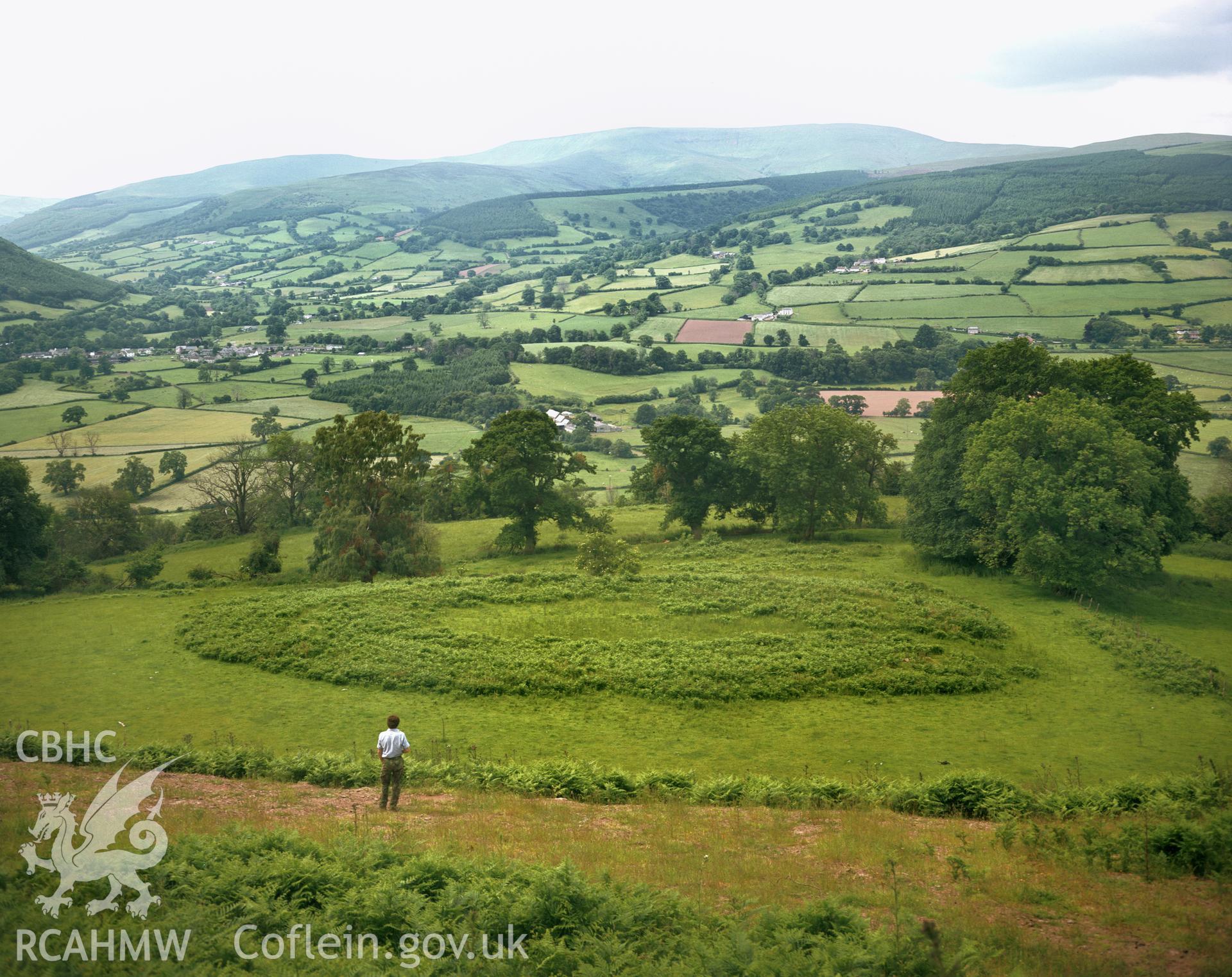 RCAHMW colour transparency showing landscape view of Allt yr Esgair Enclosure, taken by I.N. Wright, c.1980.
