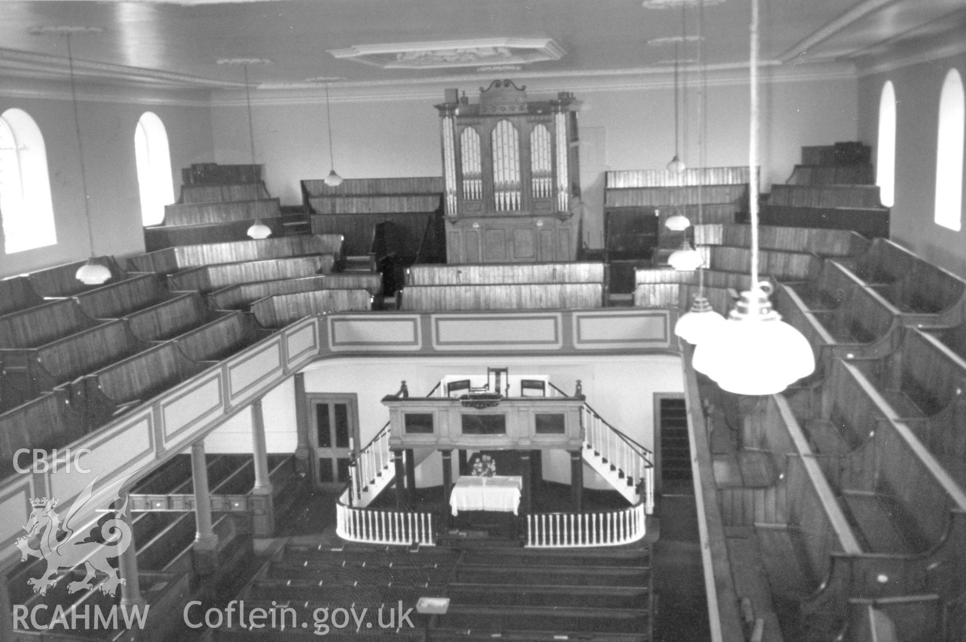 Digital copy of a black and white photograph showing an interior view of Zion Wesleyan Methodist Chapel, Pembroke Dock, taken by Robert Scourfield, c.1996.