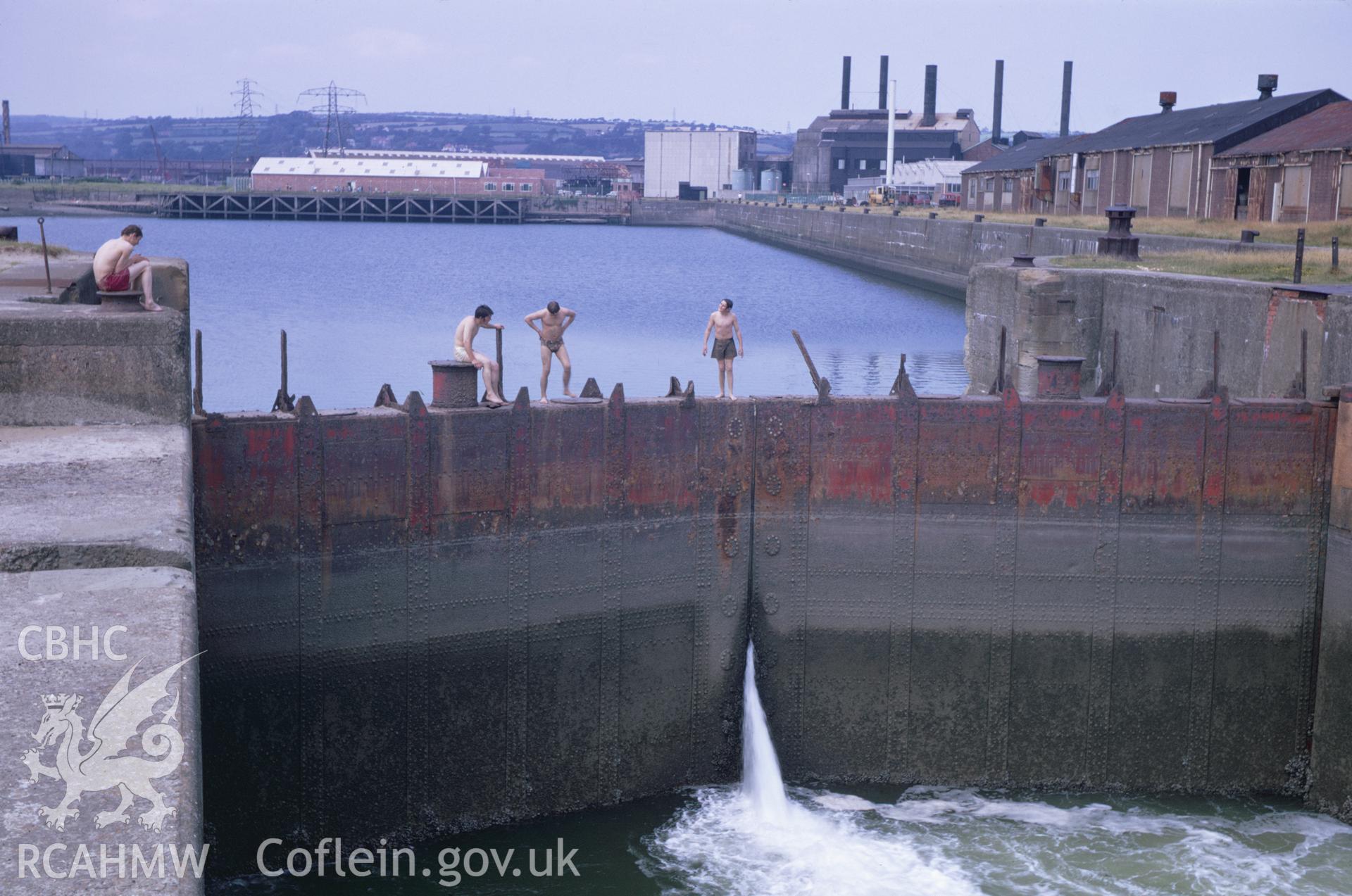 35mm Slide of the lock gates at the North Dock, Llanelli, Carmarthenshire featuring figures (boys)  in swimming costumes, by Dylan Roberts.
