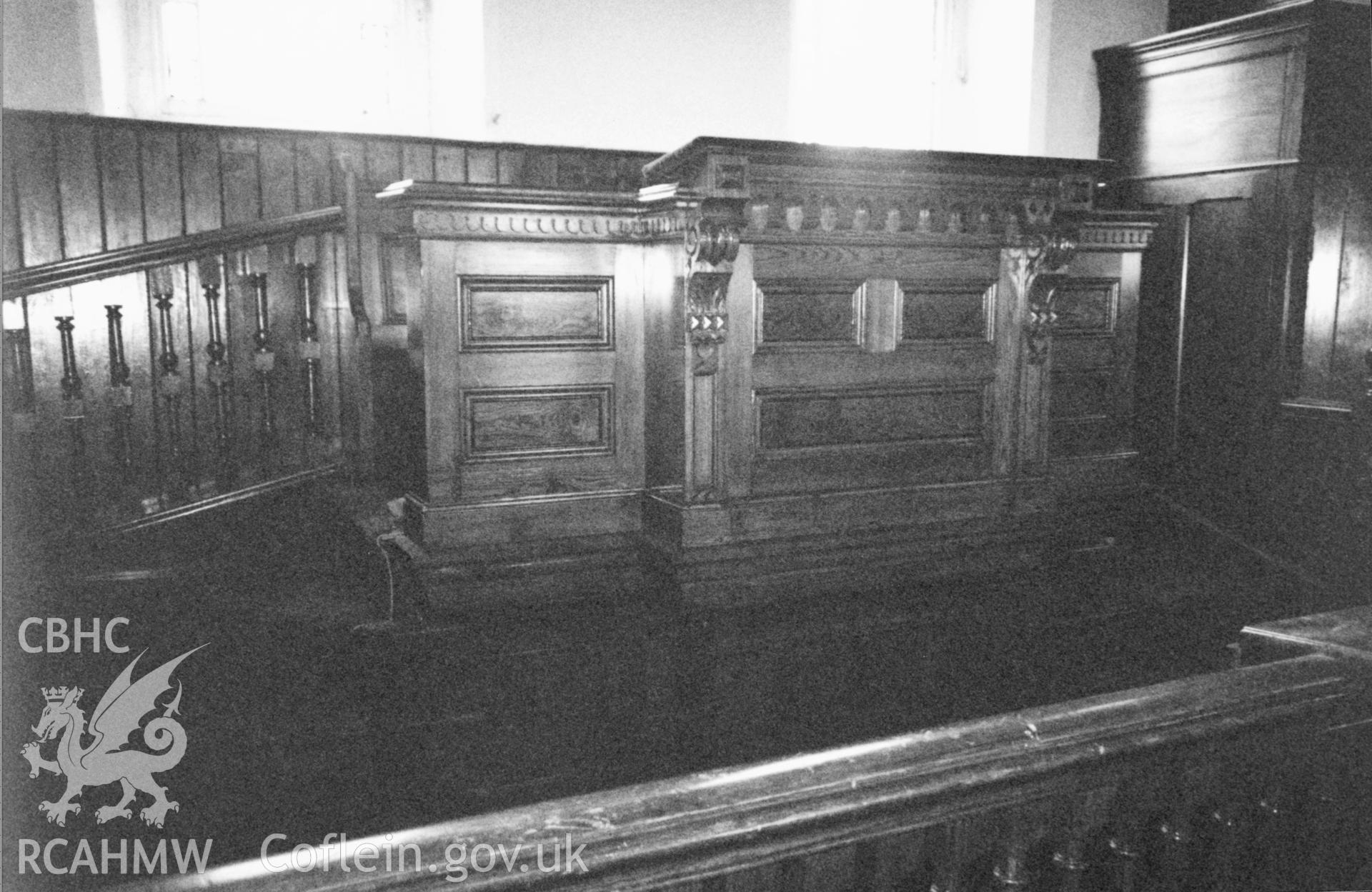 Digital copy of a black and white photograph showing an interior view of Seion Calvinistic Methodist Chapel, Llansadwrn, taken by Robert Scourfield, 1996.