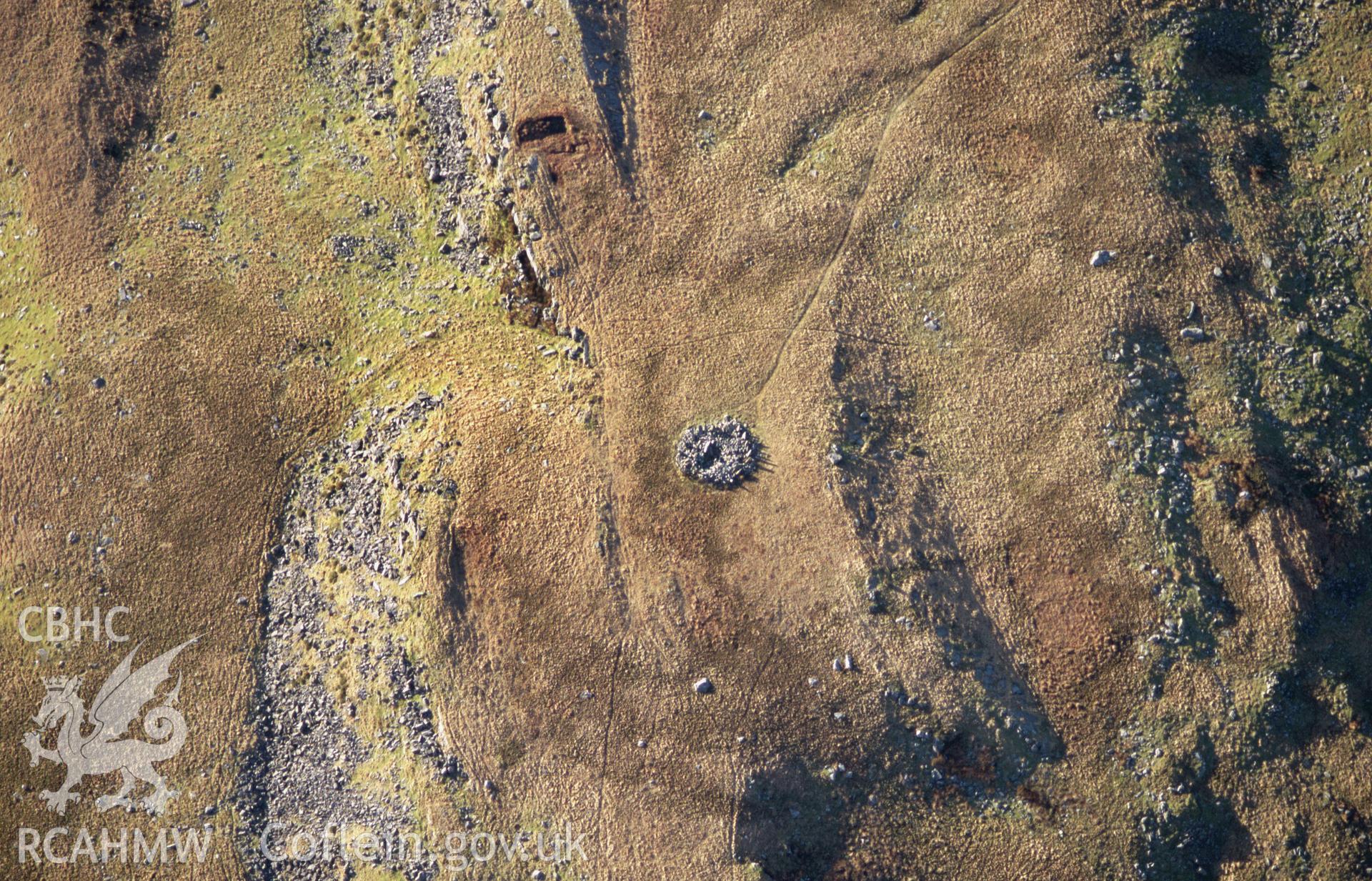 Slide of RCAHMW colour oblique aerial photograph showing cairn on Bryn Cader Faner, Talsarnau, taken by T.G. Driver, 2005.