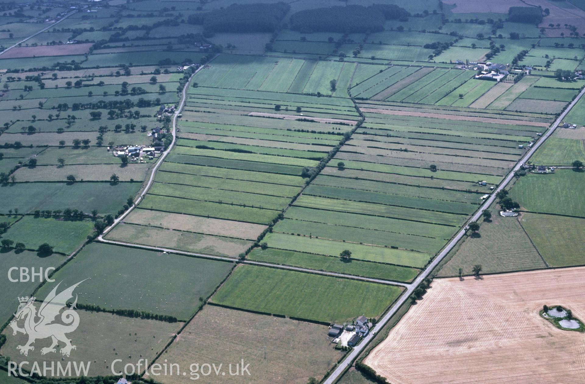 RCAHMW colour slide oblique aerial photograph of Commonwood, Holt, taken by C.R. Musson, 13/08/94