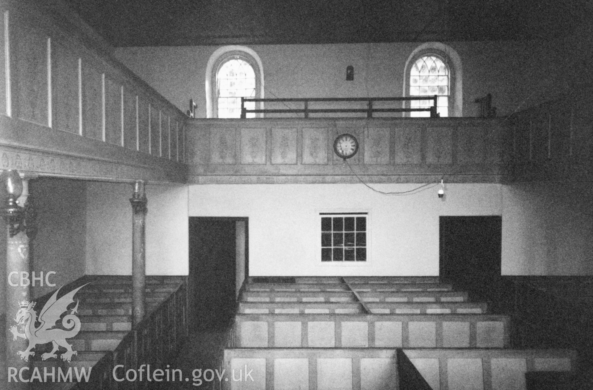 Digital copy of a black and white photograph showing an interior view of Libanus Baptist Chapel, Llansadwrn, taken by Robert Scourfield, 1996.