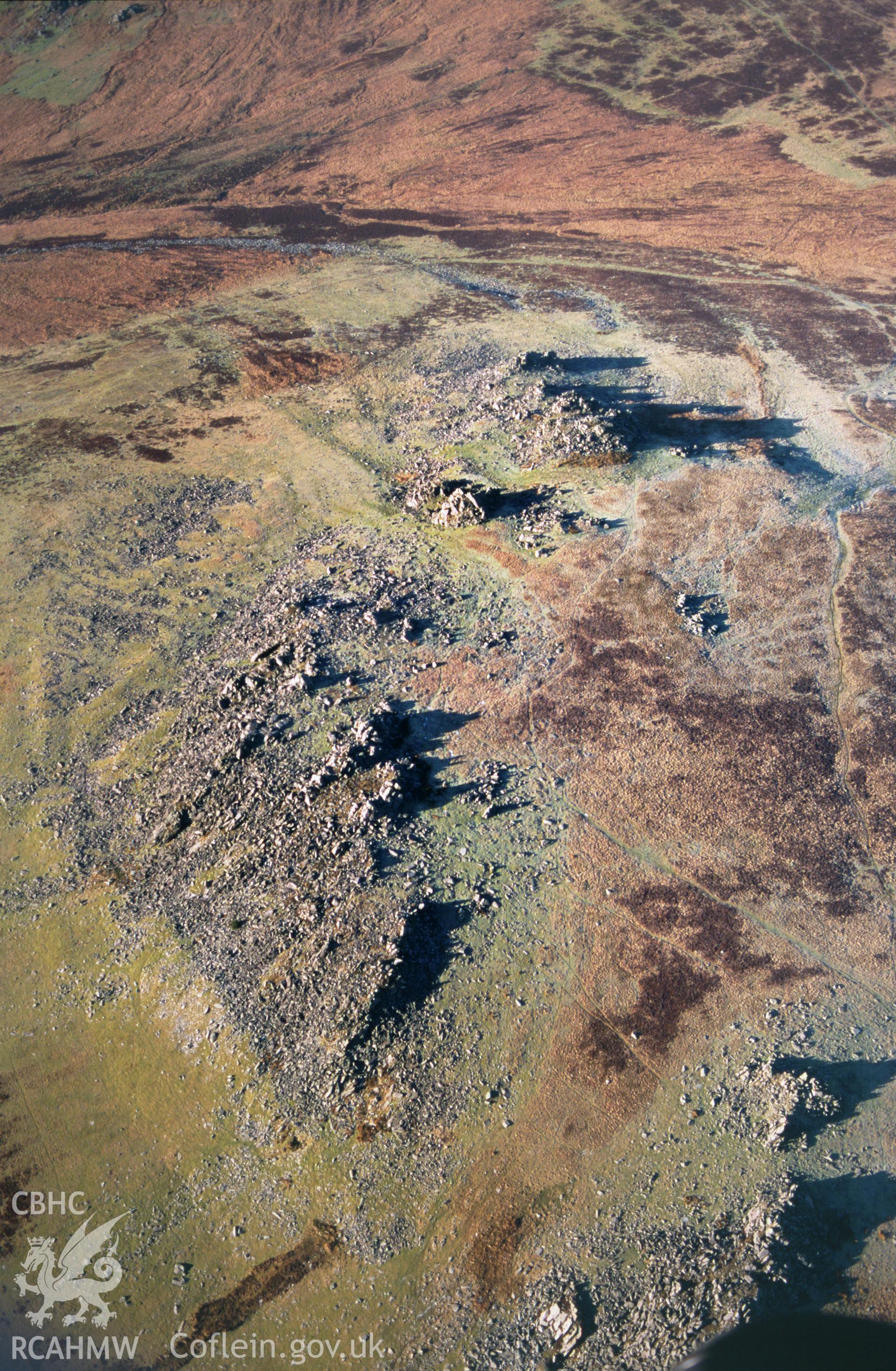 RCAHMW colour slide oblique aerial photograph of a bluestone outcrop at Carnmenyn, Mynachlog-ddu, taken on 19/12/1999 by Toby Driver