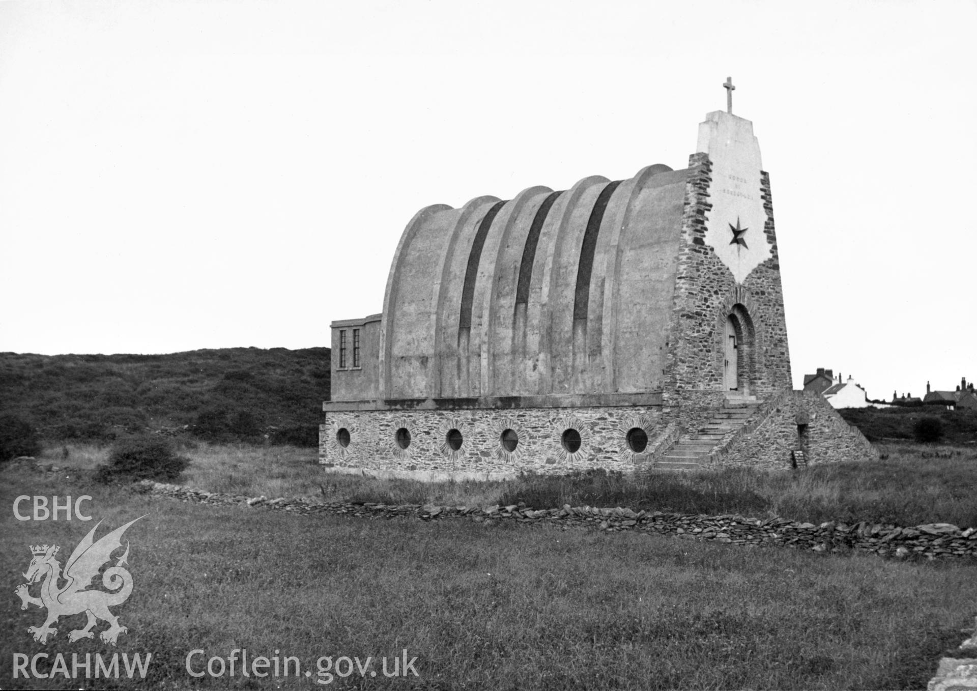 View of Our Lady Star of the Sea catholic church, Amlwch taken in 1947. The church was designed in c1939 by Guiseppe Rinvolucri, an Italian architect brought to Wales as a prisoner of war. He subsequently married a local woman, and lived and worked in north Wales, specialising in Roman Catholic churches. He also designed a number of other churches in Wales, including those at Abergele, and Porthmadog.
