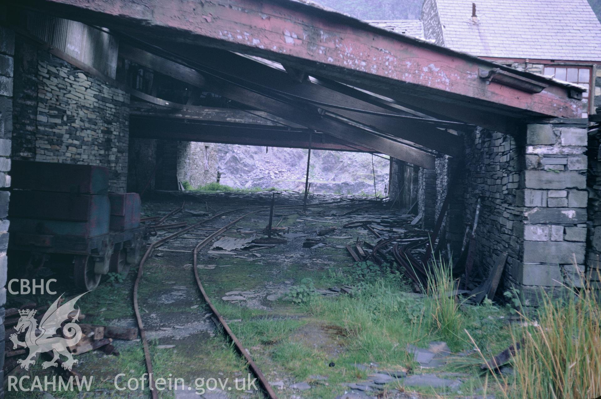 Colour 35mm slide of Oakley Slate Quarry Blaenau Ffestiniog, showing loading shed, by Dylan Roberts, undated.