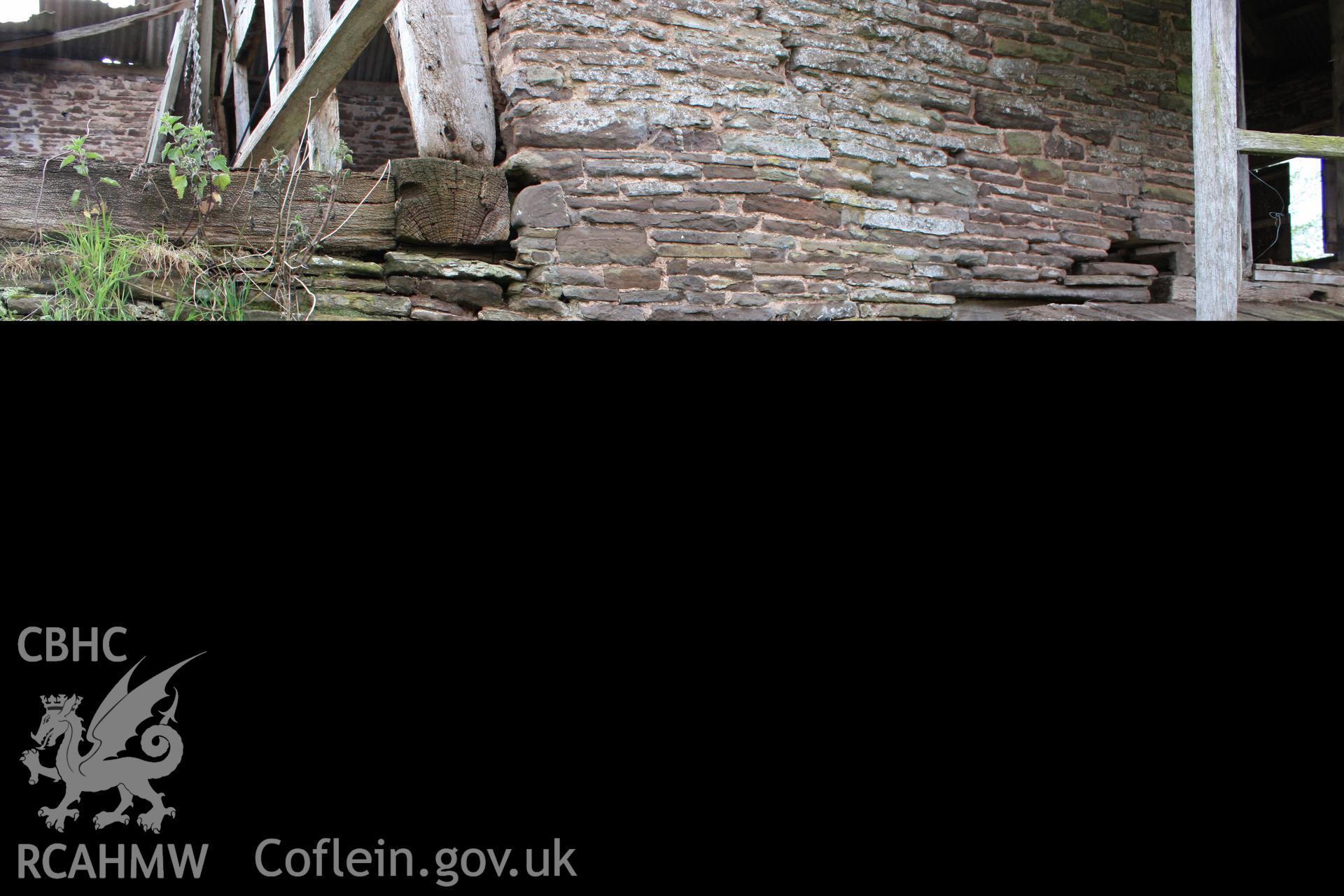View from north-east showing barn range wall & cattle doorway at low end.