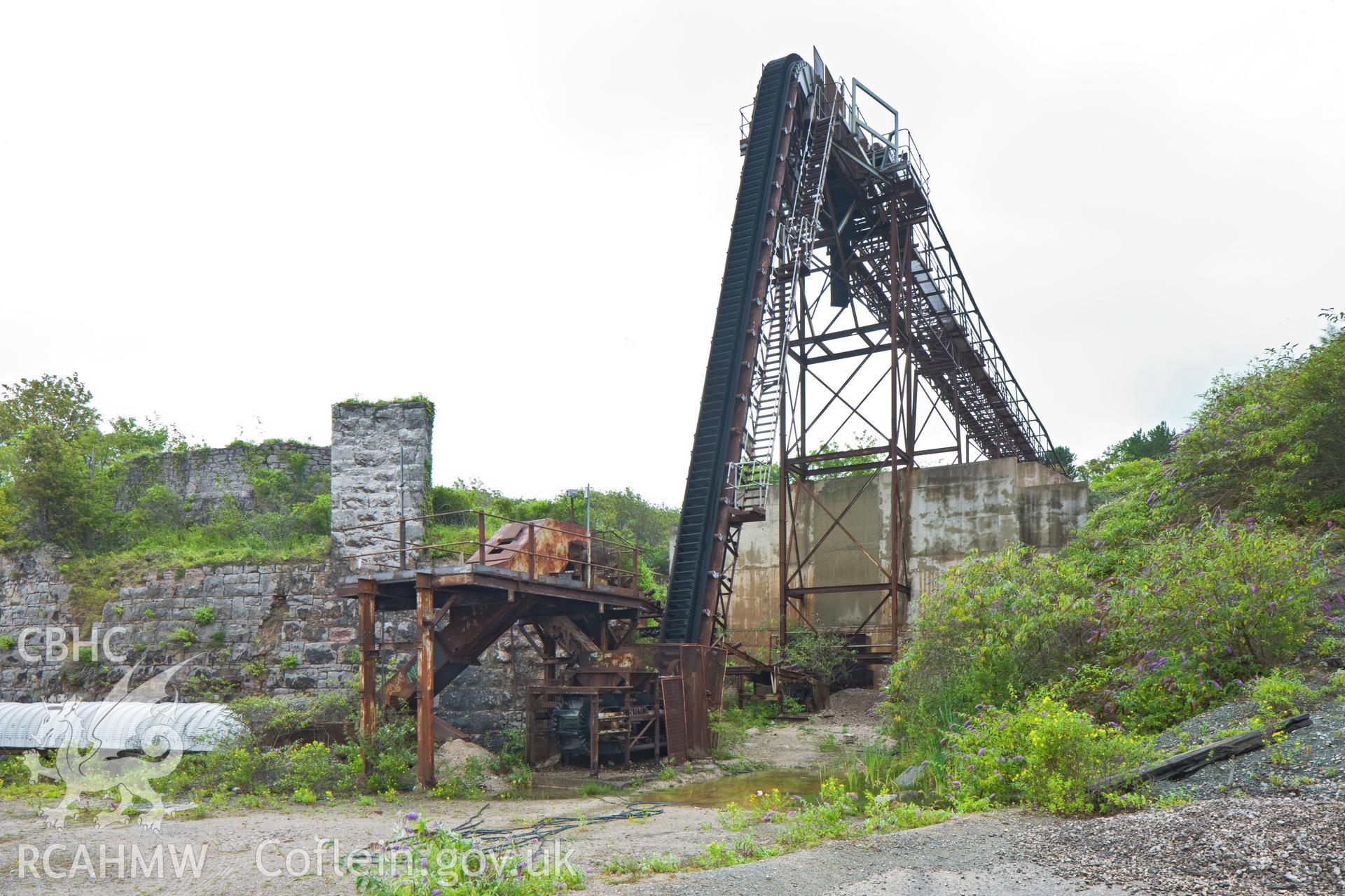 Tunnel to quarry with overhead conveyor.