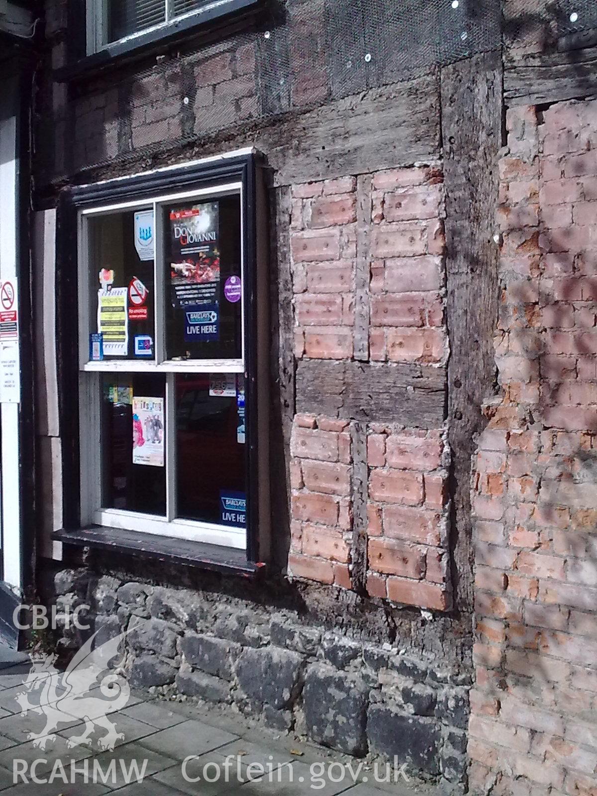 Front Facade - to the right of central door, beam resting on stone foundation, brick infill panels