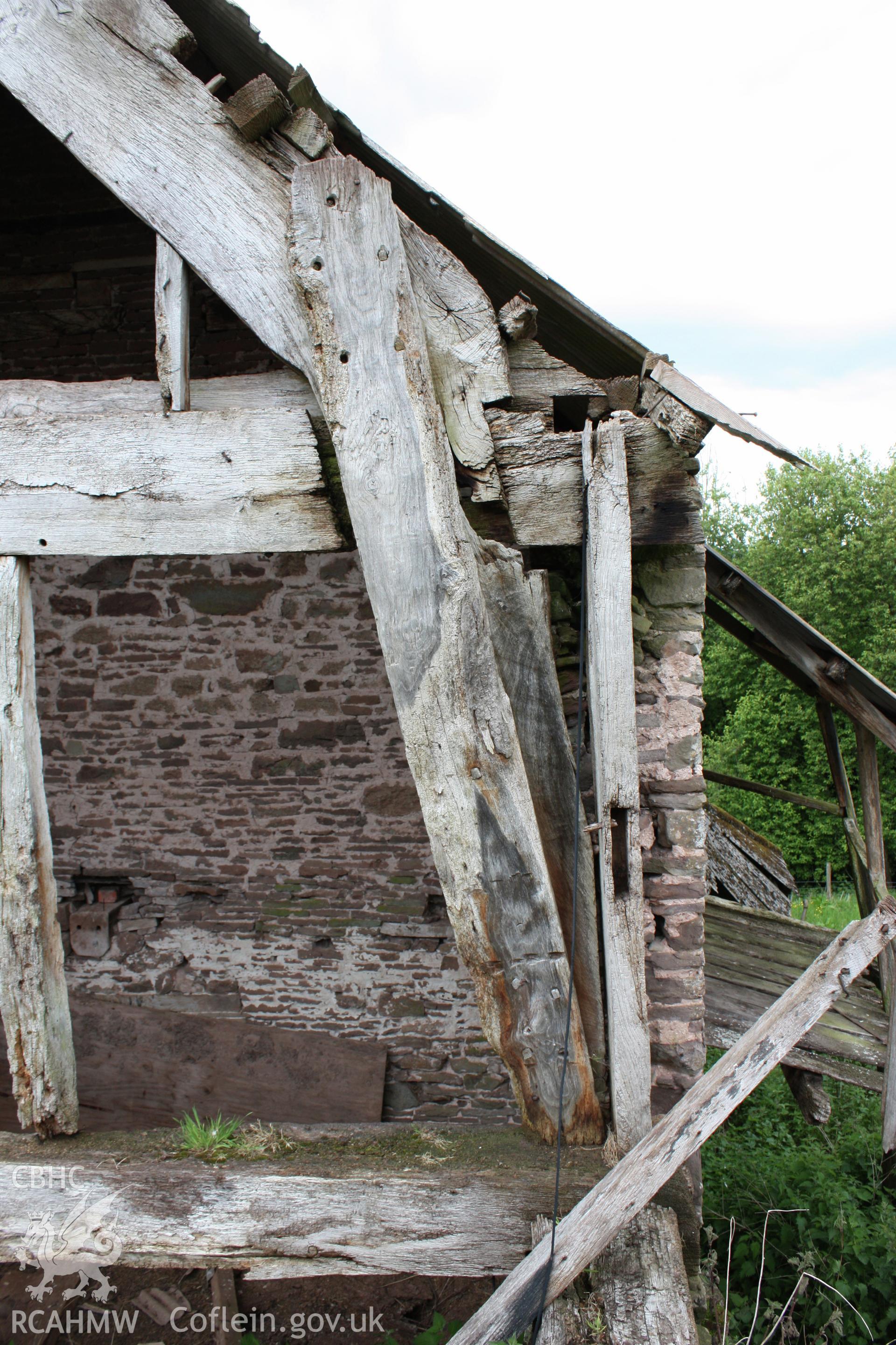 Interior of Barn range showing the lower end cruck truss, detail.