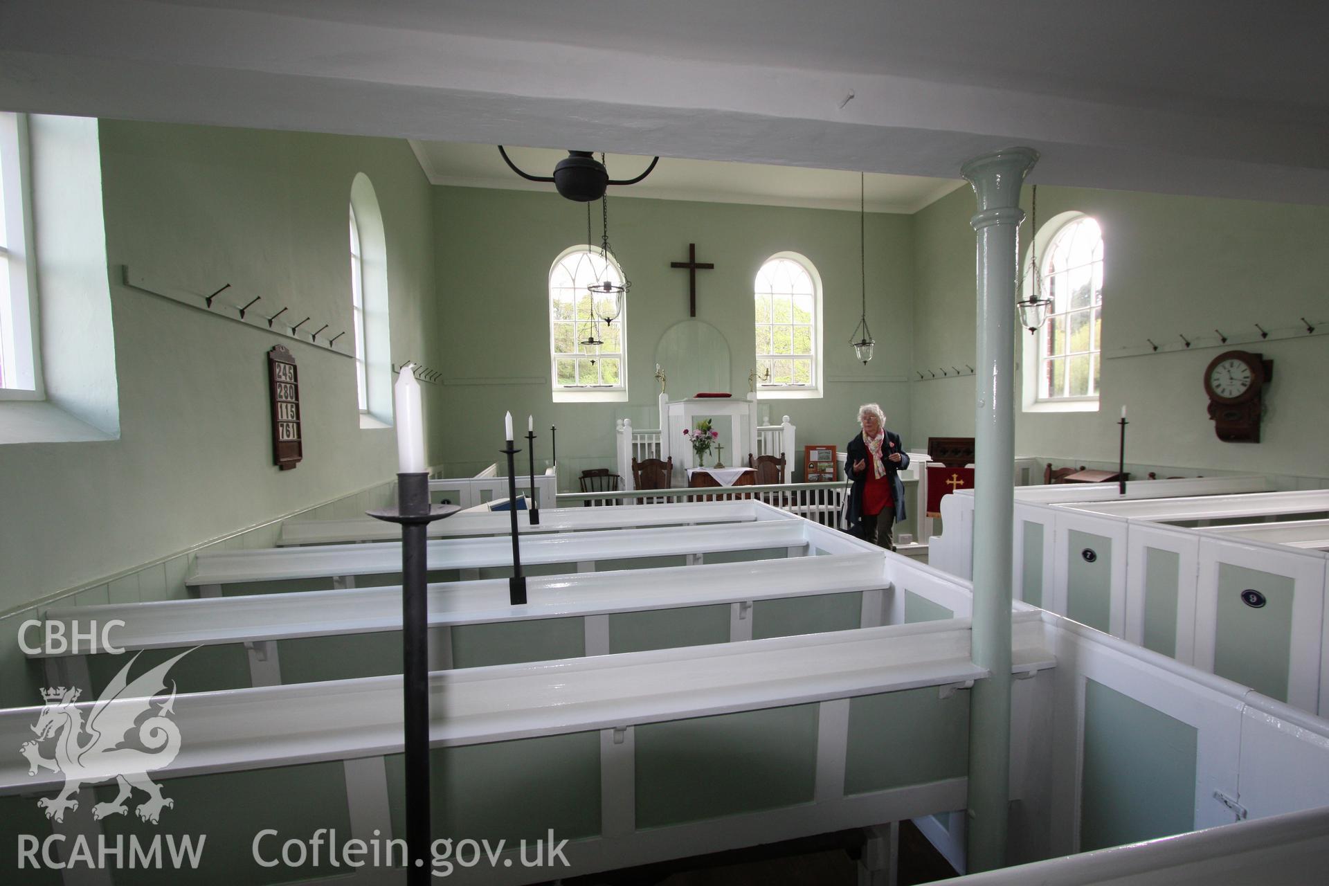 Interior, view towards pulpit, showing column & box pews