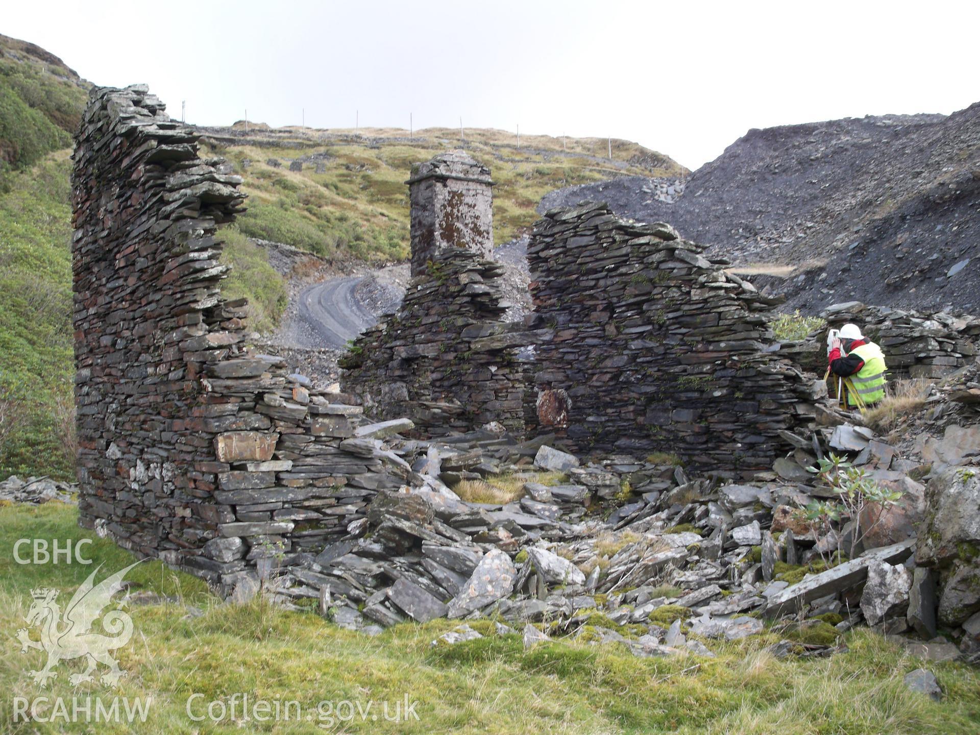 Surveying the end (north-west) Maenofferen Cottage (NPRN 416226). Visible on the left hand side of the image is the gable end showing the surviving roofline.