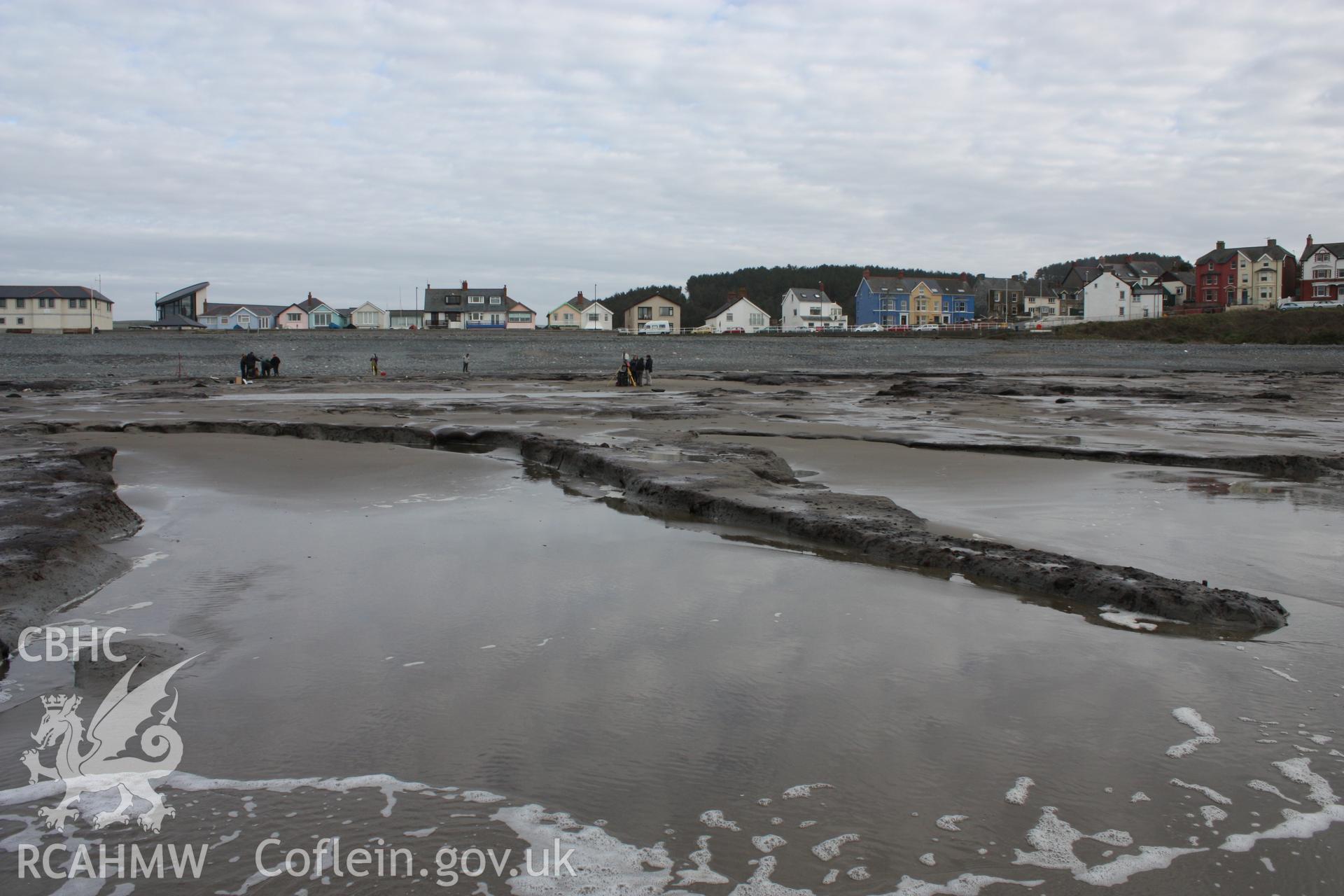 Borth submerged forest (between RNLI lifeboat station and upper Borth), looking east towards High Street. Showing peat exposures below lifeboat station at low tide