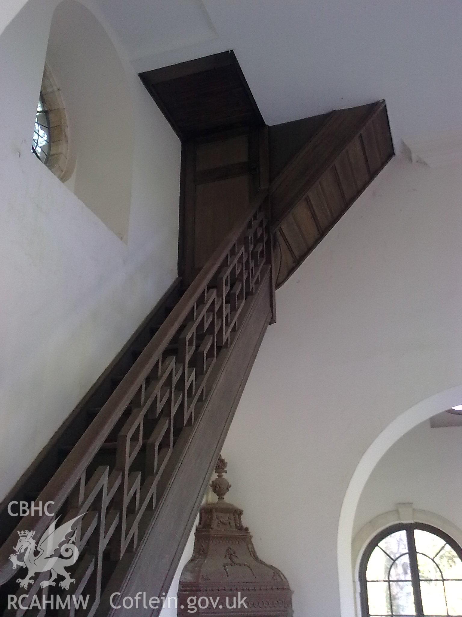Staircase and ornate bannisters climbing to first floor.