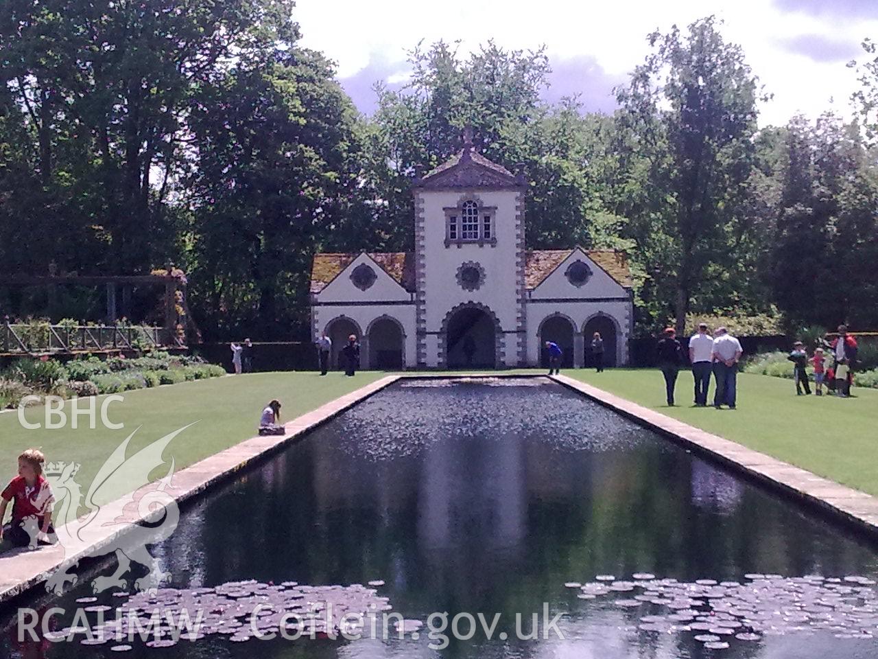 Long lily pond leading the front facade of the Pin Mill garden house.