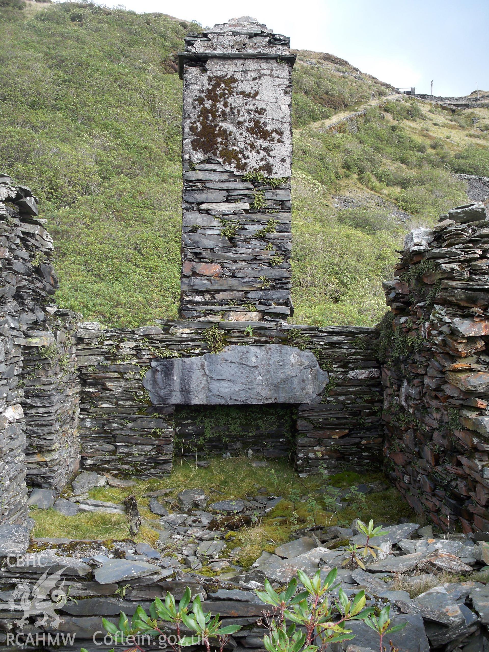 Detail of fireplace and surviving chimney in the north wall of the end (north-west) cottage. In the background can be seen Rhiwbach Incline Number 2.