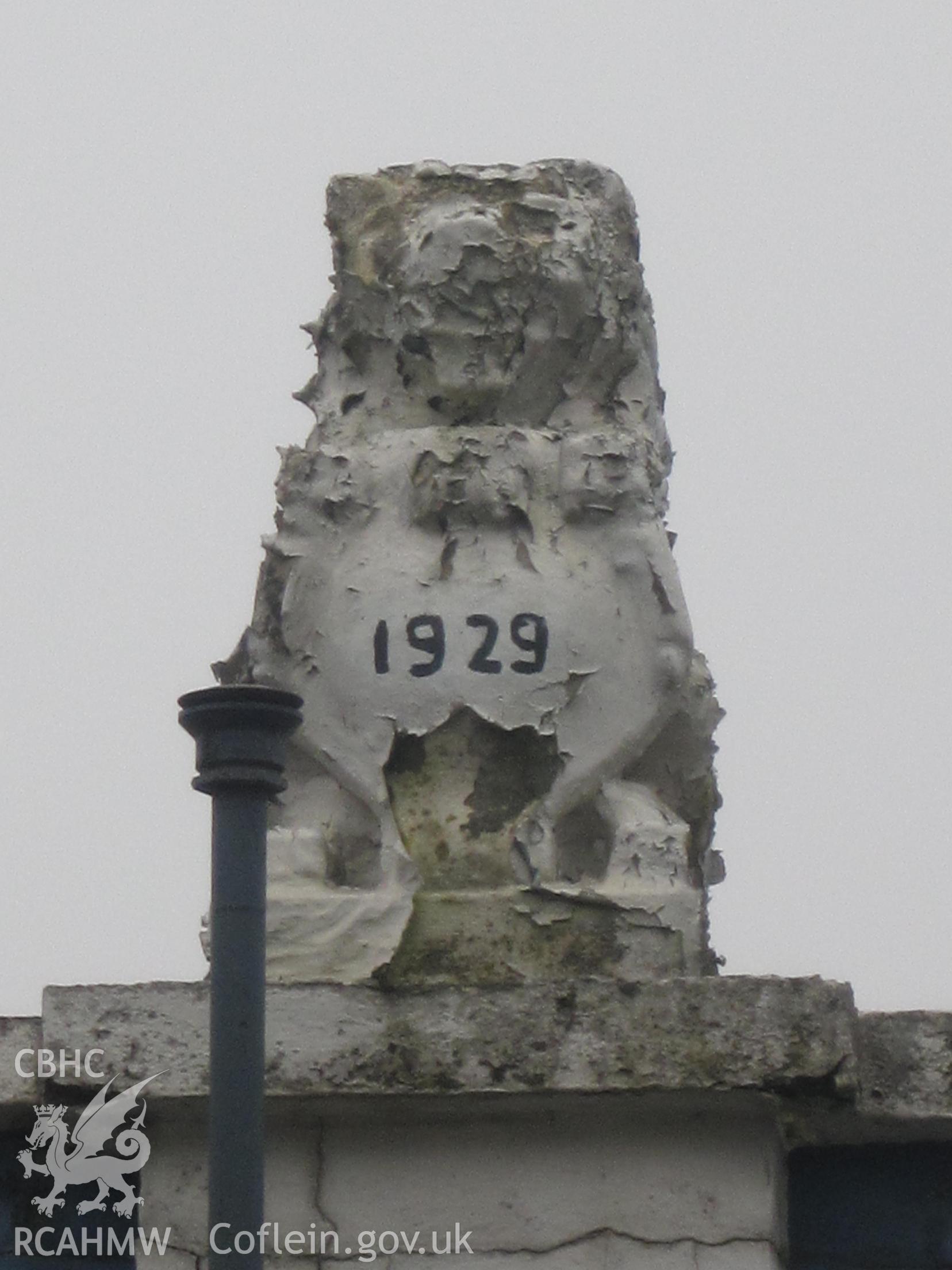 Detail of one of the eleven stone or concrete figures (lions?) on the roof of Pritchard's Garage, Llandrindod Wells.