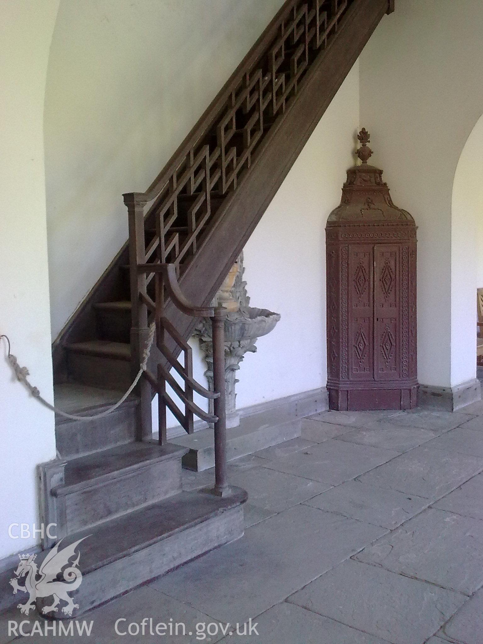 Staircase and ornate bannisters climbing to the first floor.