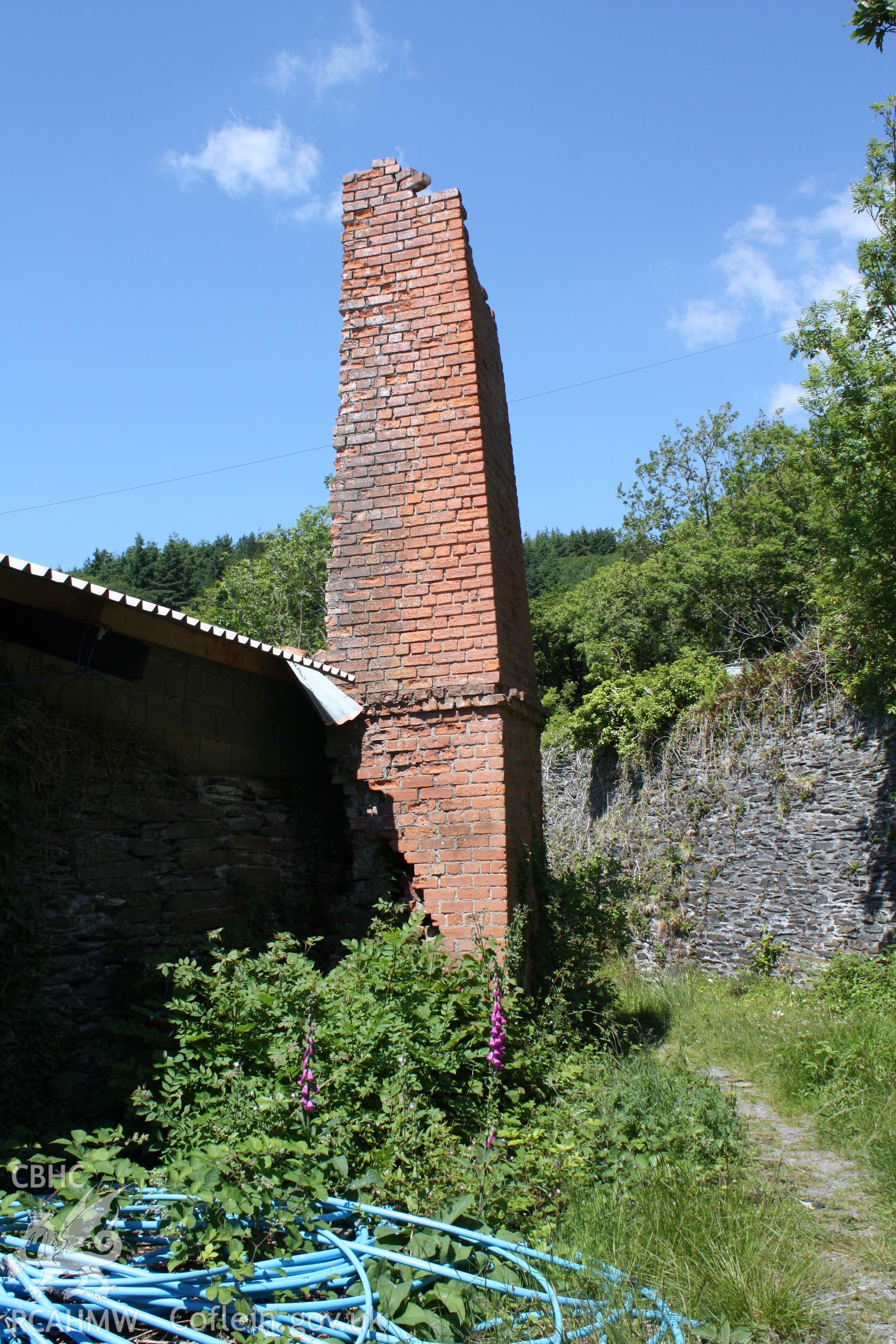 Remains of brick-built chimney stack at northern corner of eastern wall