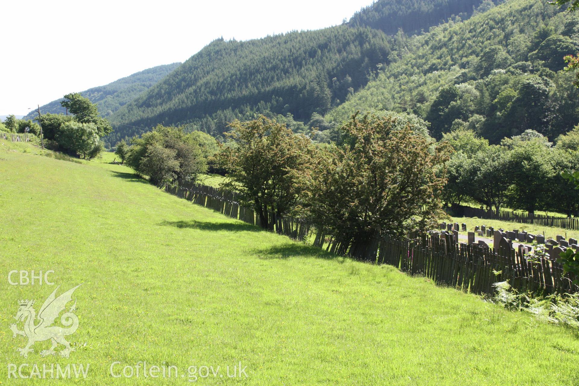 Line of the Corris Railway defined by slate fencing running running notheast out of Corris at SH7577 0811.