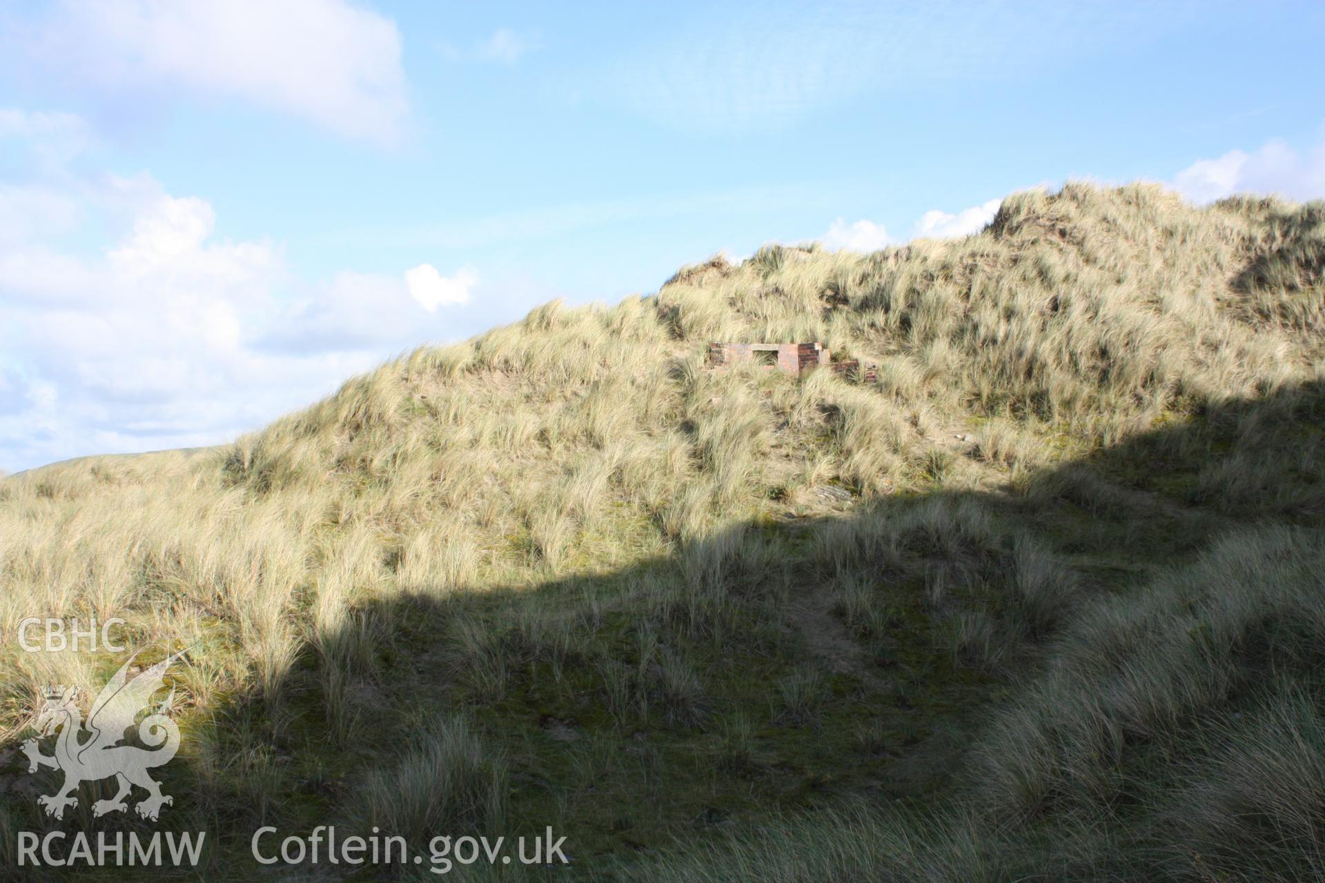 Upslope approach to pillbox from the south through shadow cast by surrouding sand dunes