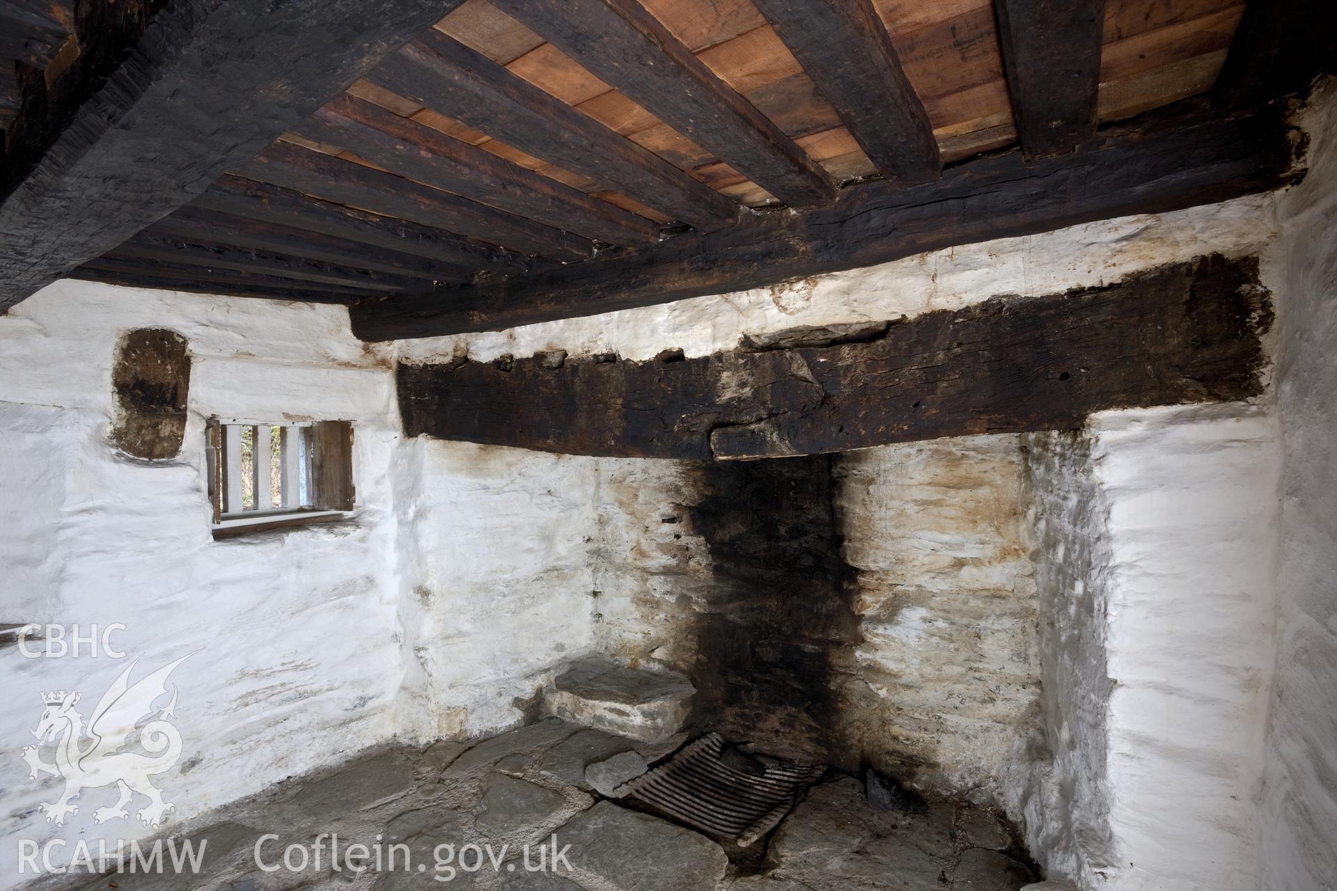 Interior, fireplace and remains of cruck in wall.