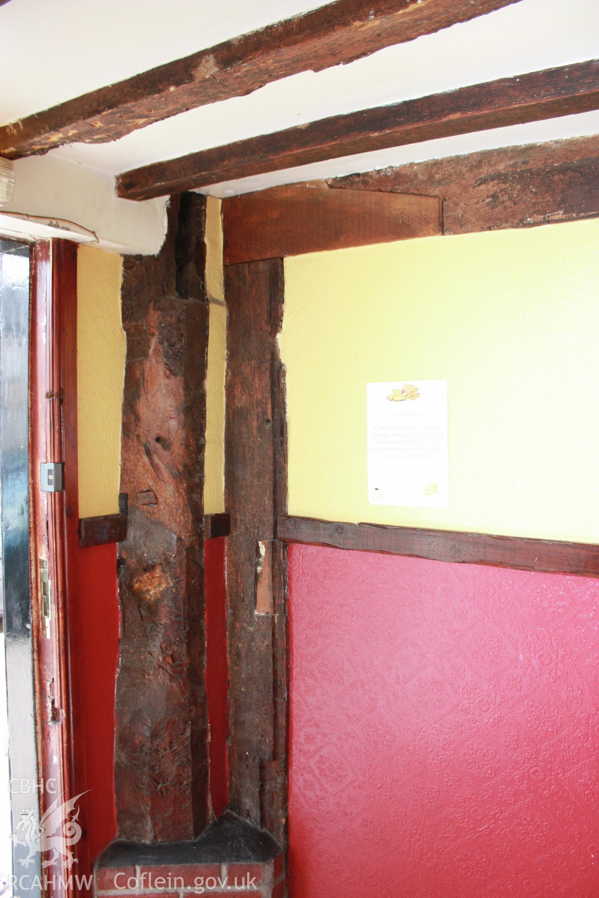 Interior, from lobby of pricipal-post at entry and kitchen/hall partition.