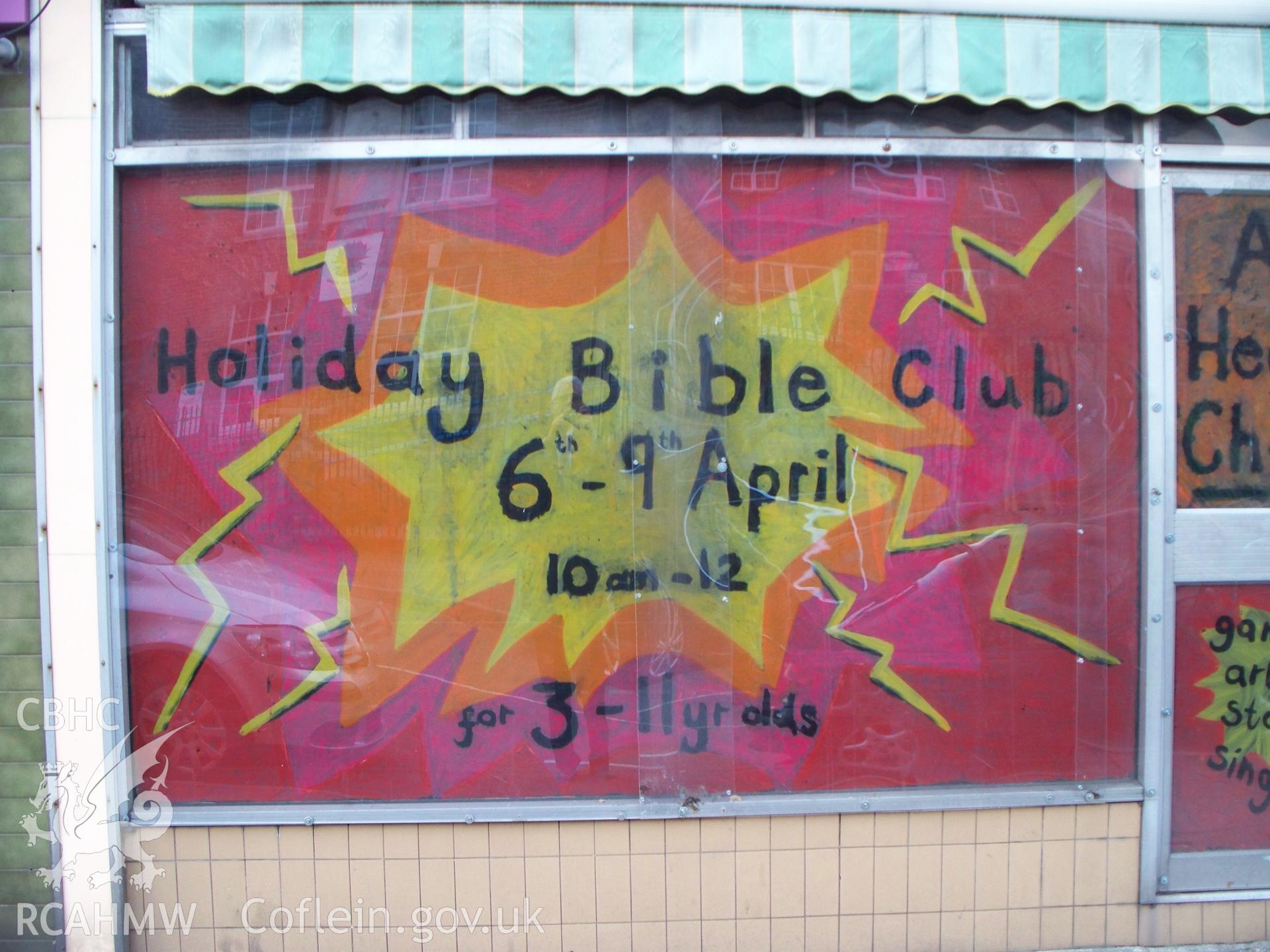 Vacant shop window on left-hand side advertising Bible Club.