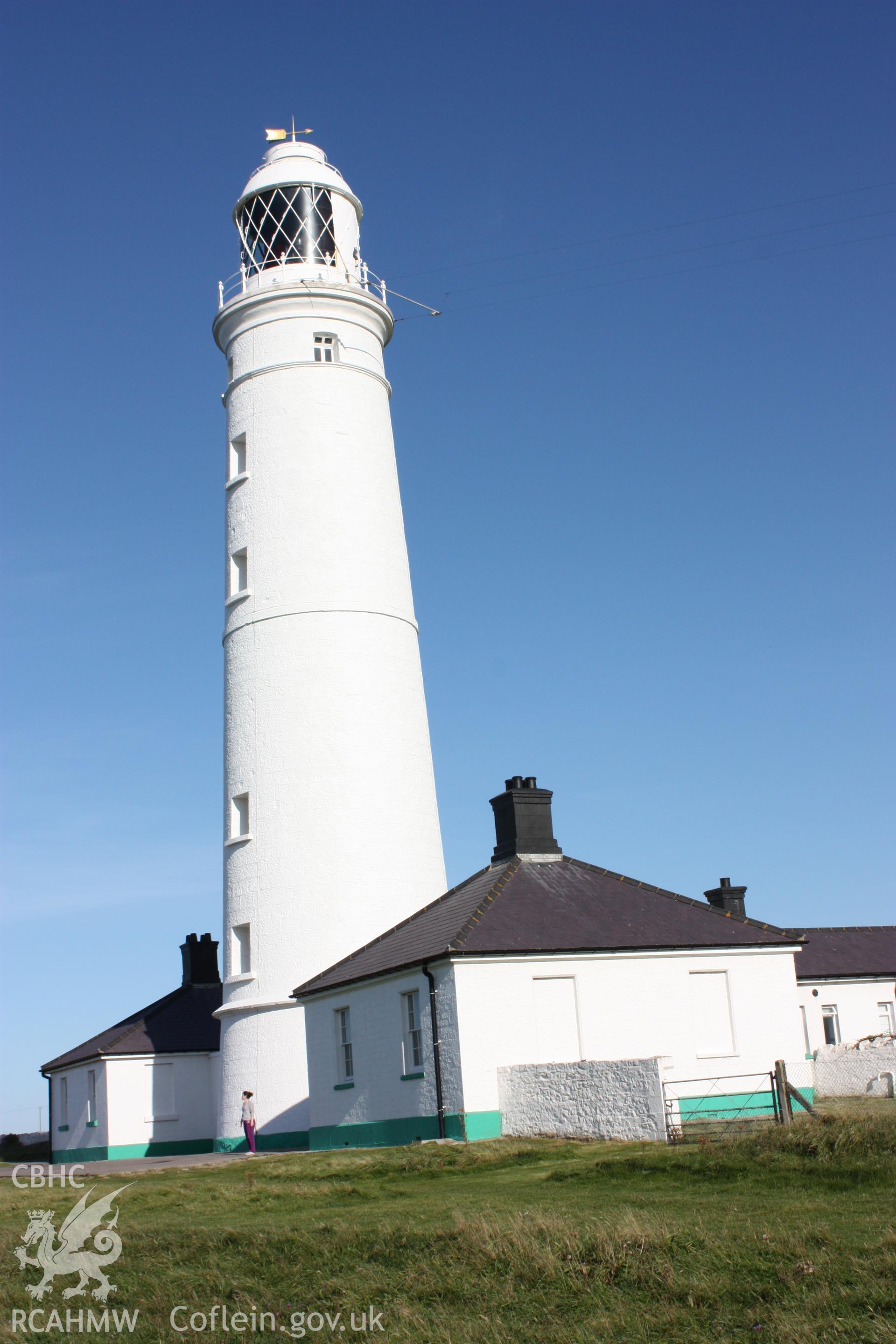 East tower with associated keeper's cottages and outbuildings with person for scale