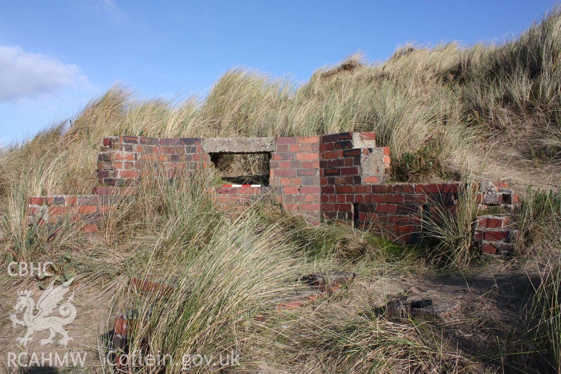 Extant northern wall and observation/firing position from interior of pillbox with photoscale