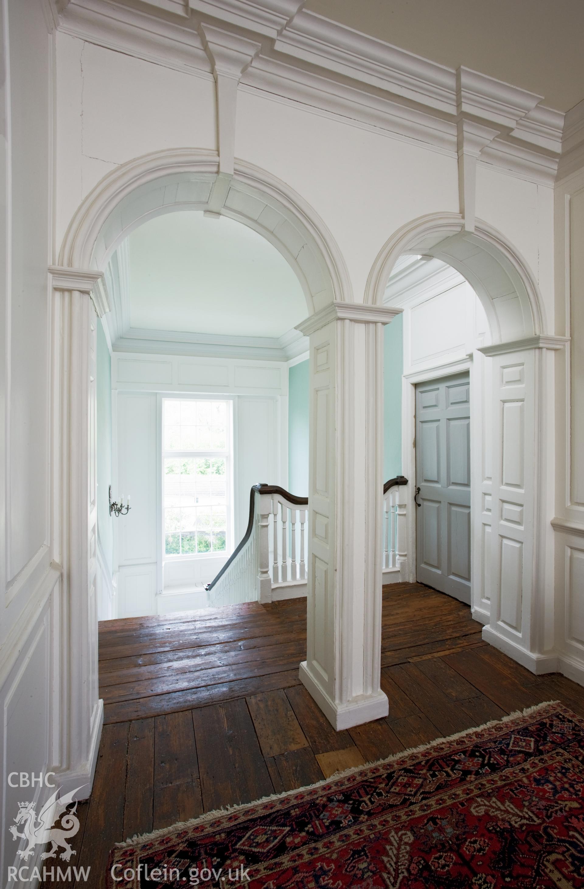 Staircase and arch on first floor.