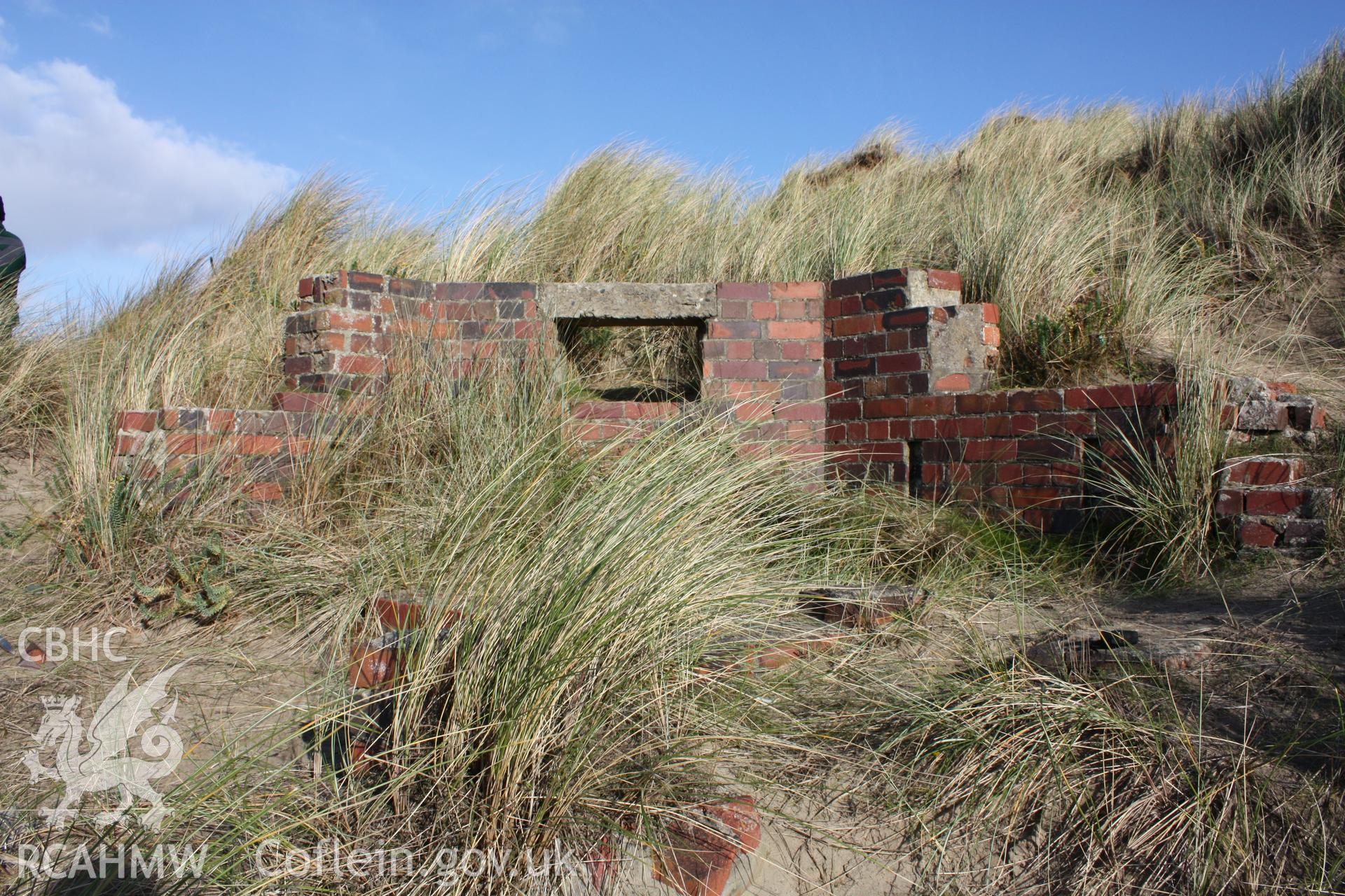 Extant northern wall and observation/firing position from interior of pillbox with photoscale