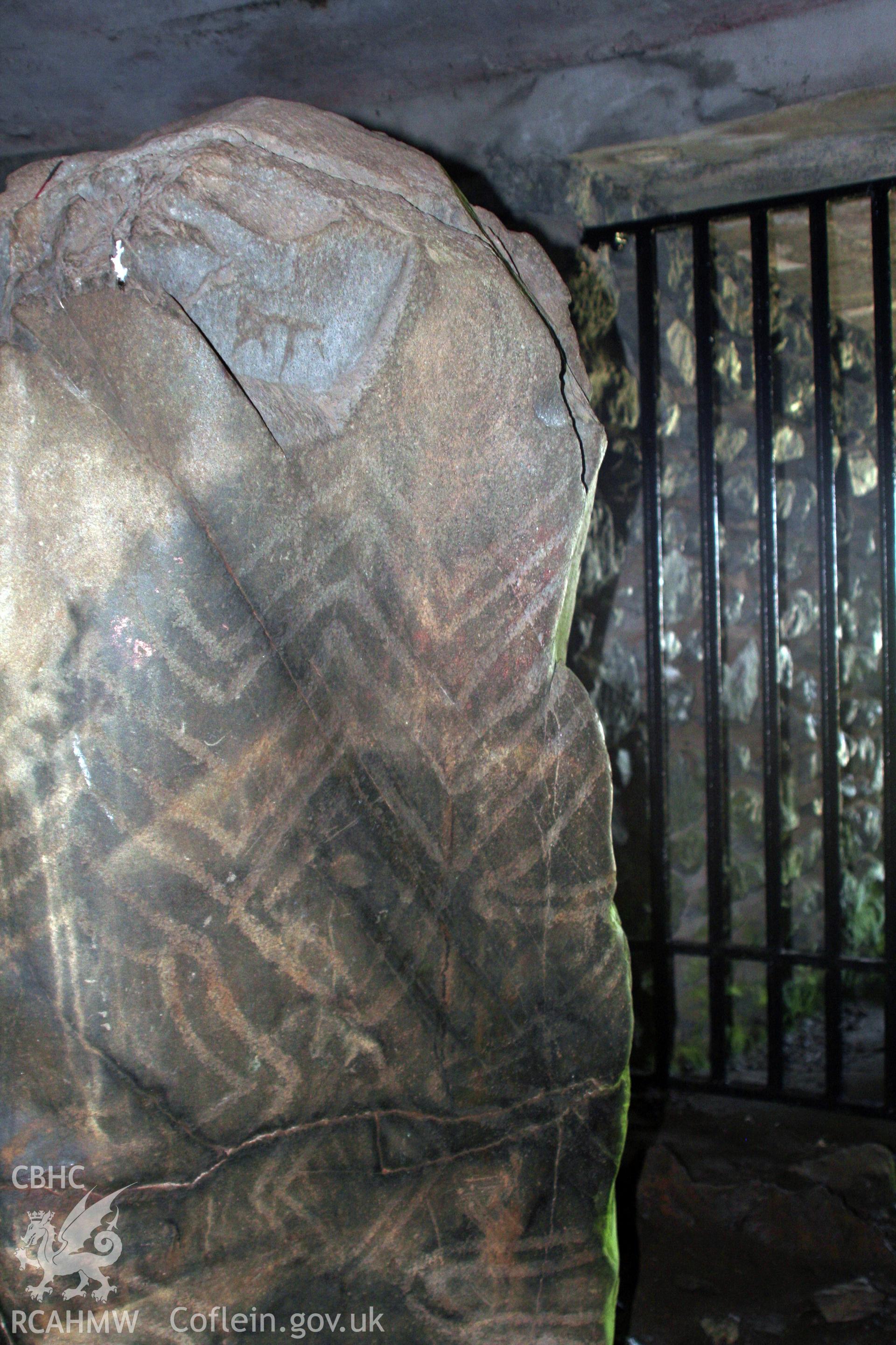 Detail of carved pillar stone with lozenge, zig-zag, spiral and wavy-line decoration on west side of tomb entrance.