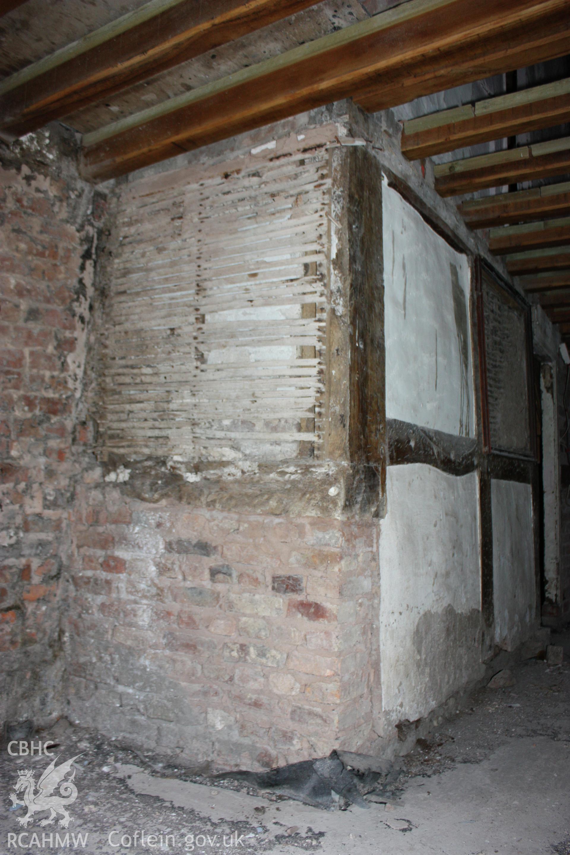 Interior, showing timber-frame to south-east elevation by entrance doorway & framed partition.