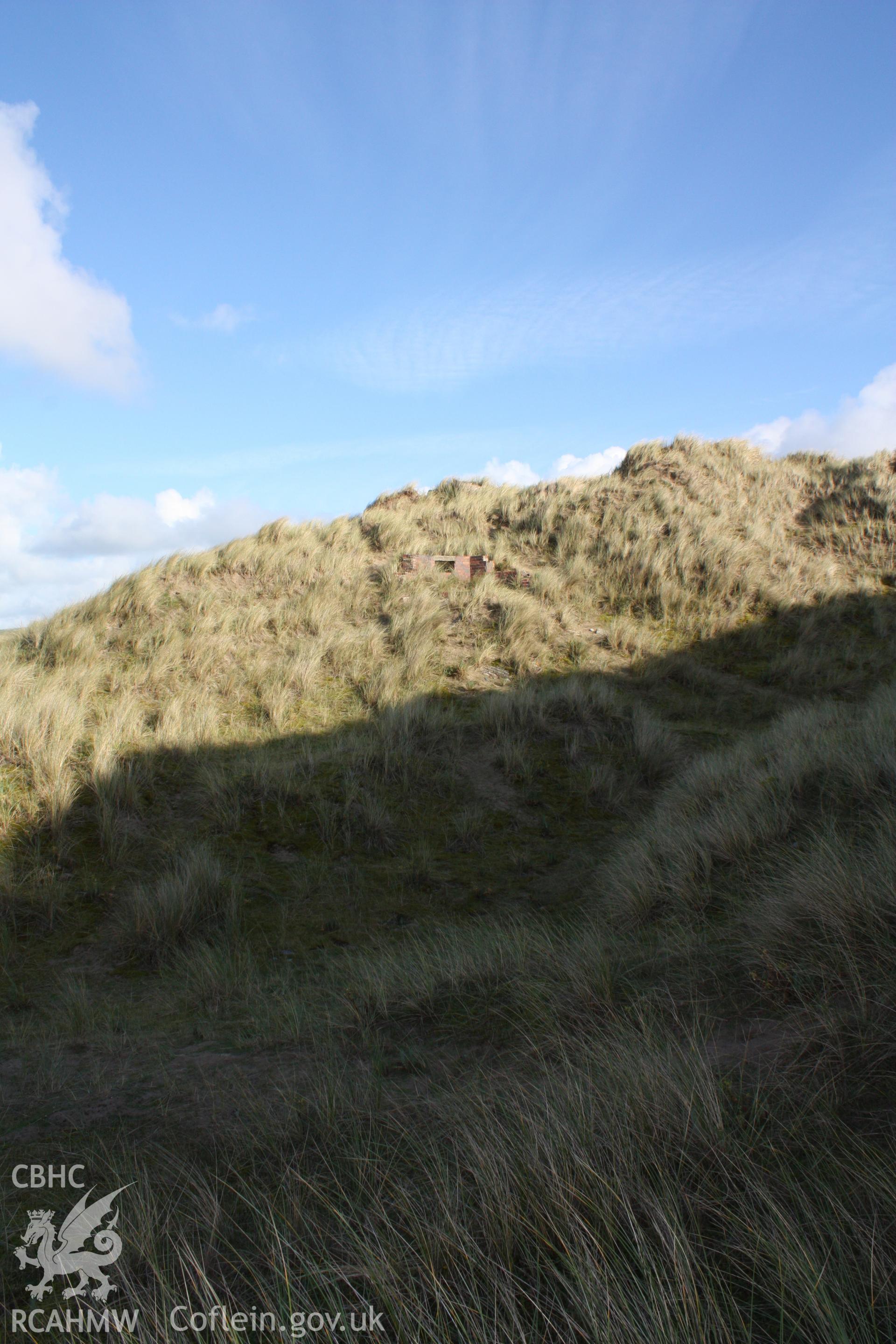 Upslope approach to pillbox from the south through shadow cast by surrouding sand dunes