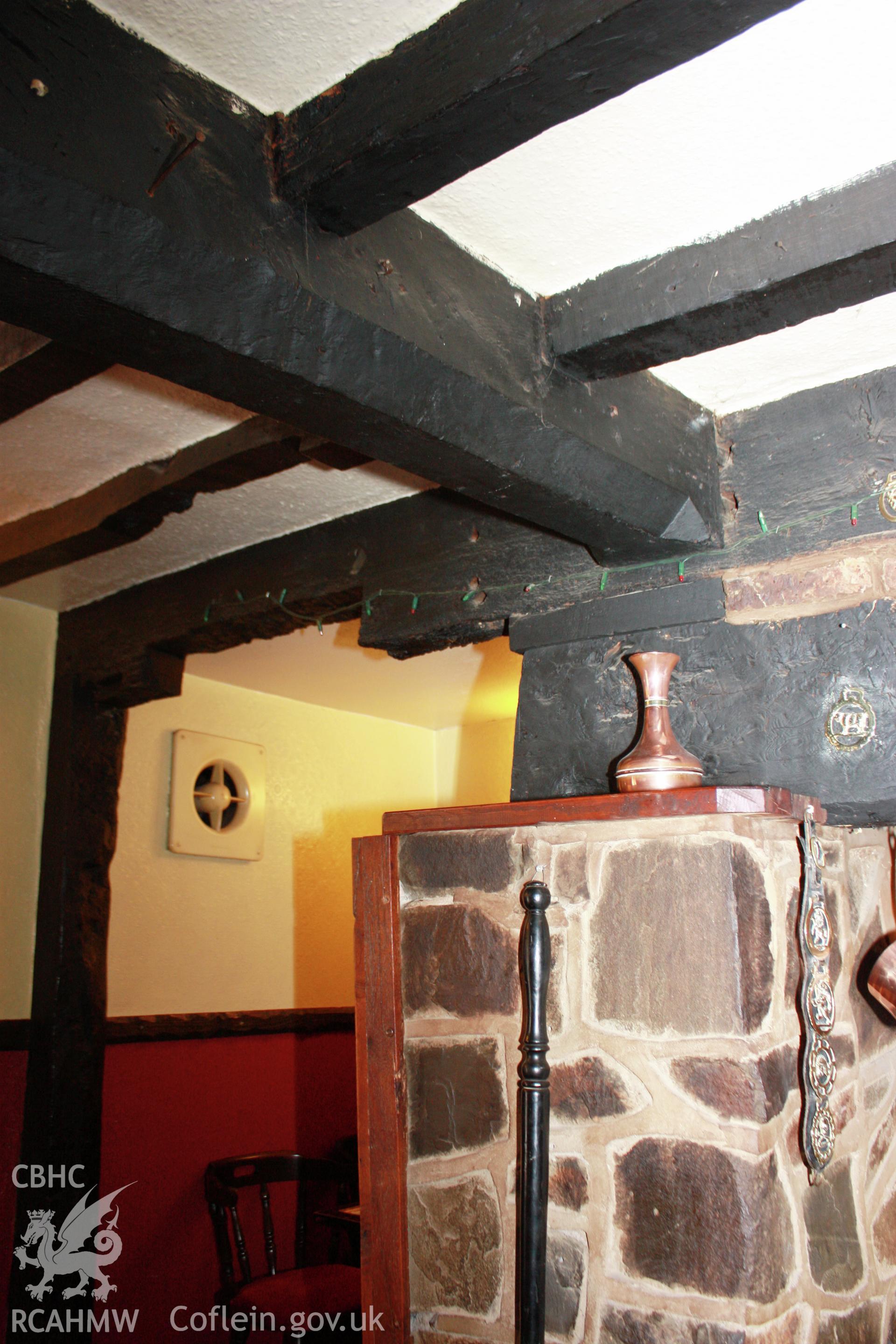 Interior, Kitchen/hall, detail of ceiling-beams at end fireplace.
