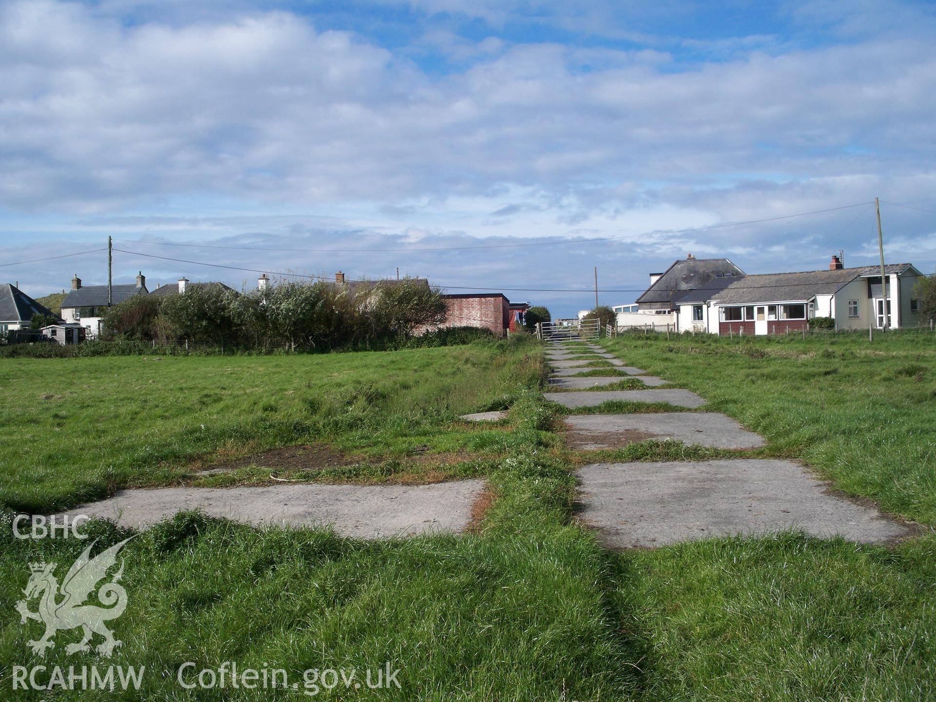Access track looking west showing T-junction of access track to former accommodation huts