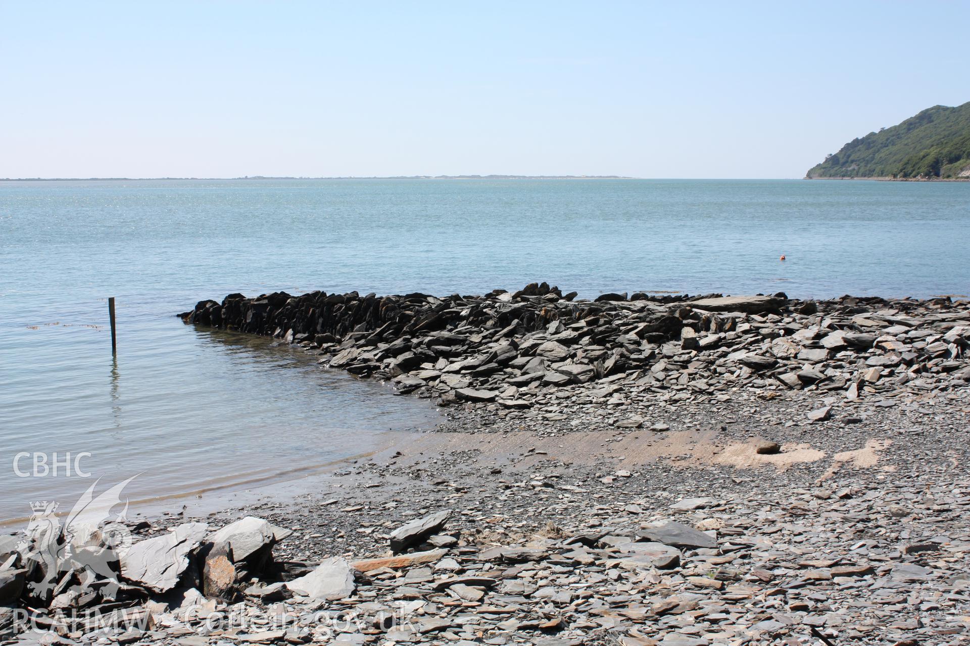 Ruinous breakwater arm of harbour (with view across estuary to Ynyslas in background)