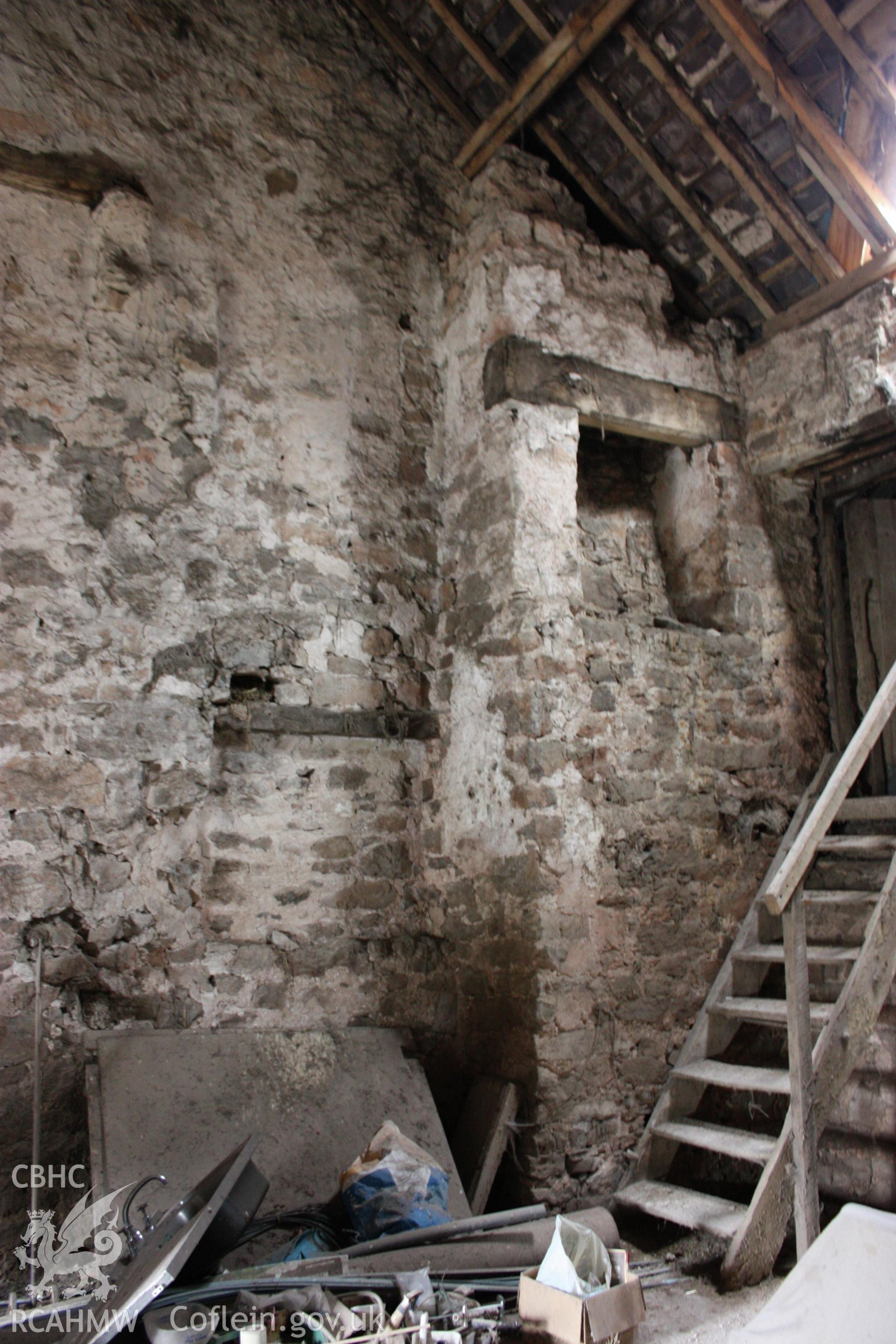 Interior, rear wing, north gable-end, showing other first-floor fireplace & stair adjacent farmbuilding.