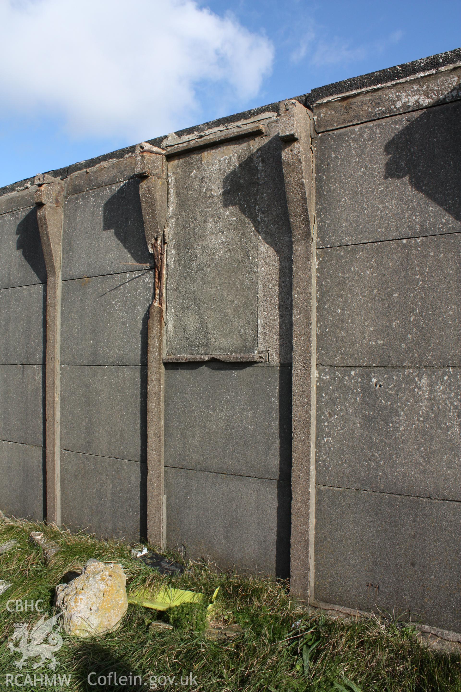 Concrete uprights and panels of the western wall of the BCF with infilled window