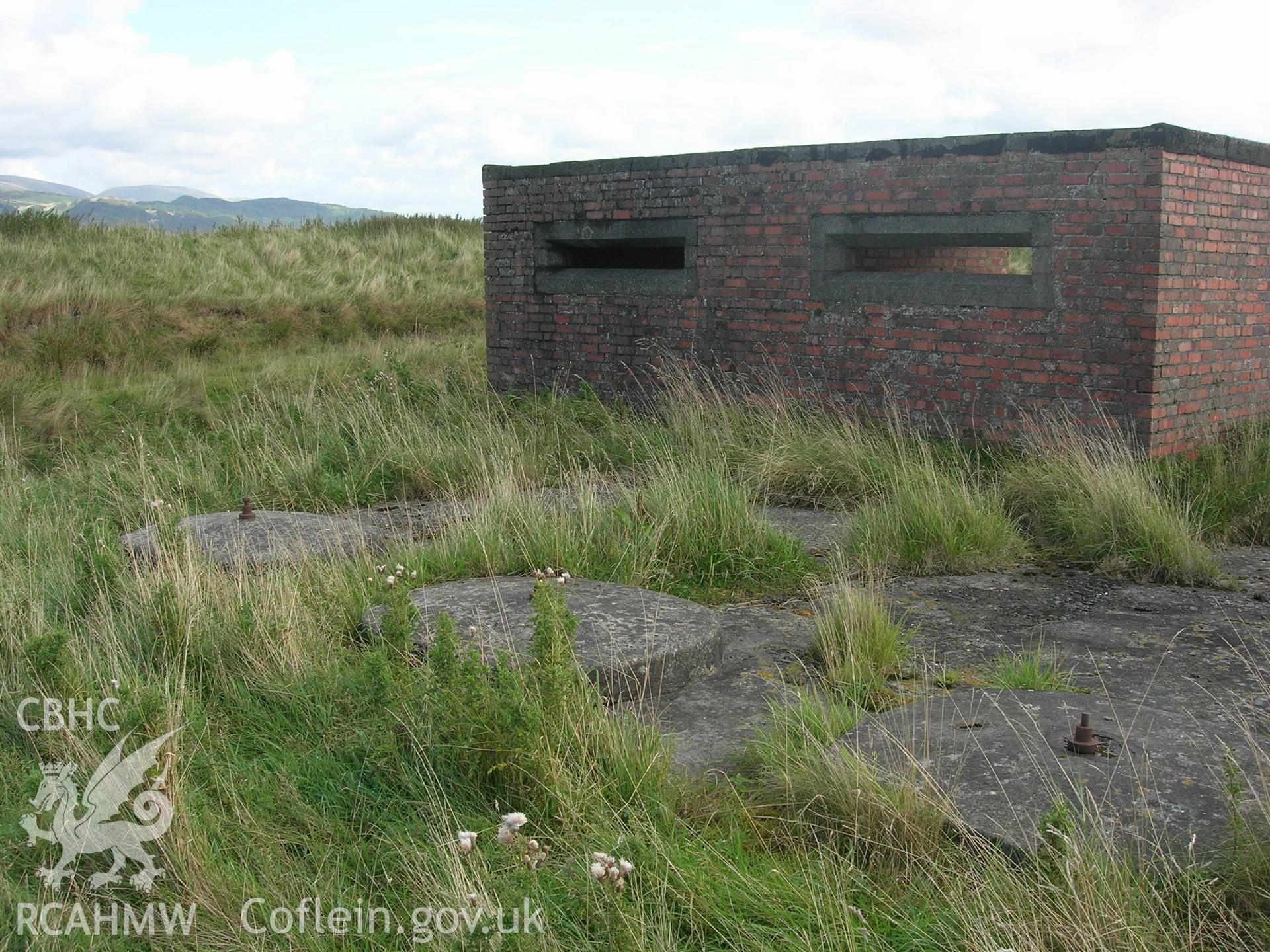 Facade facing the estuary with concrete bases possibly for a Kine radar system to track projectiles fired over Traeth Maelgwyn