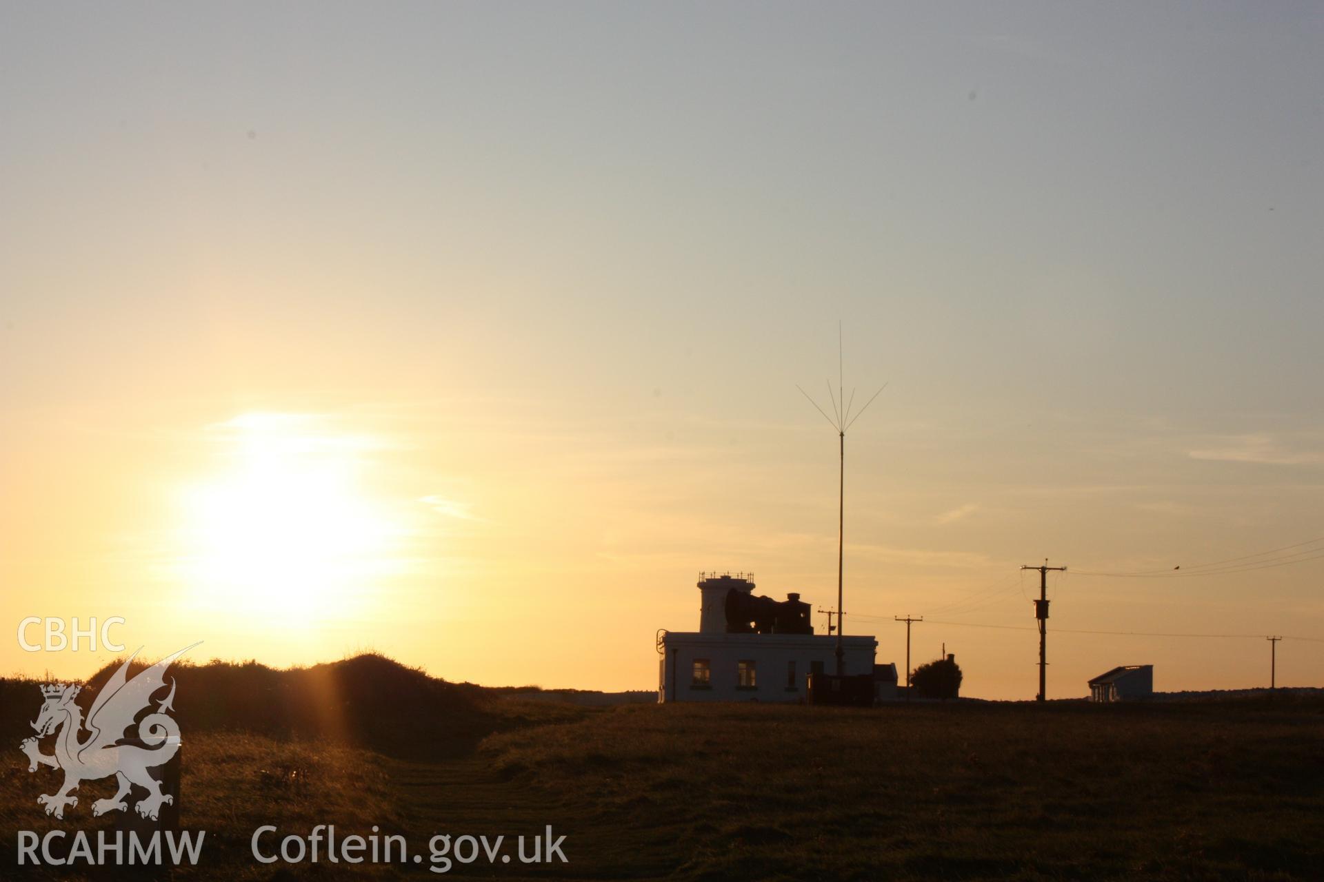 Foghorn building with west tower behind, from east at sunset