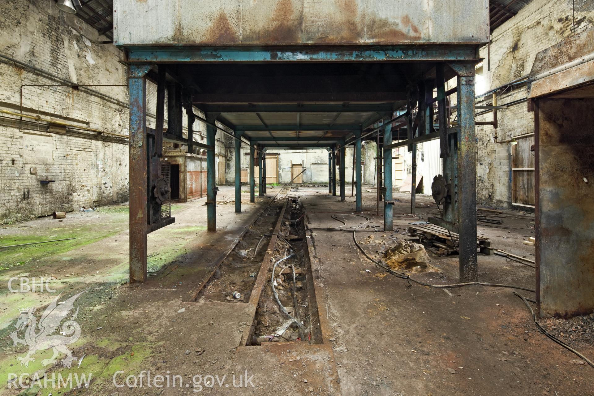 East wing interior, central tank viewed from the south southwest, iron slab floor below.