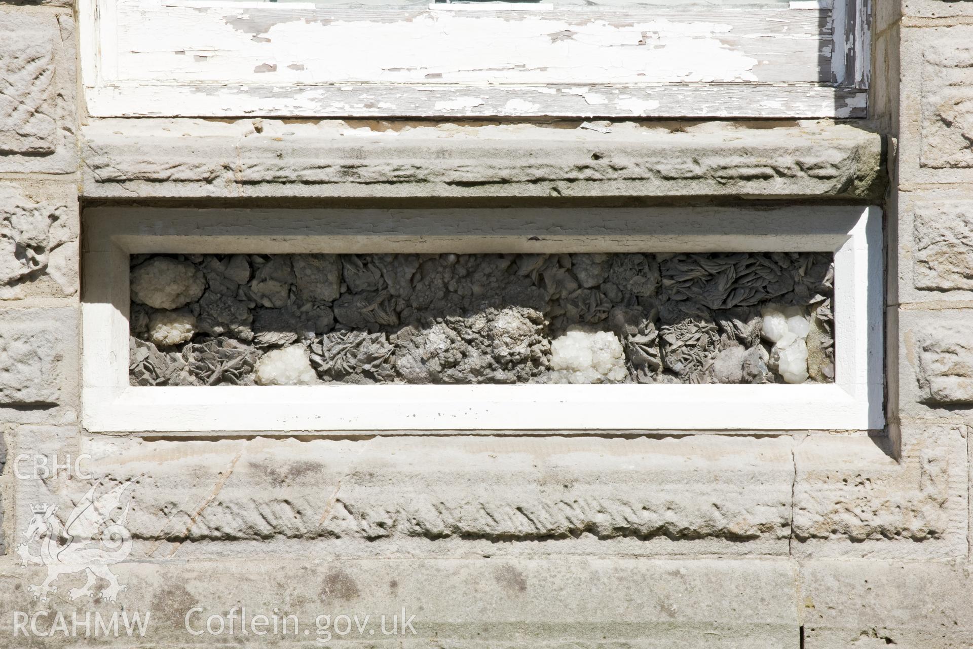Detail of rock sample decoration below (L) window.